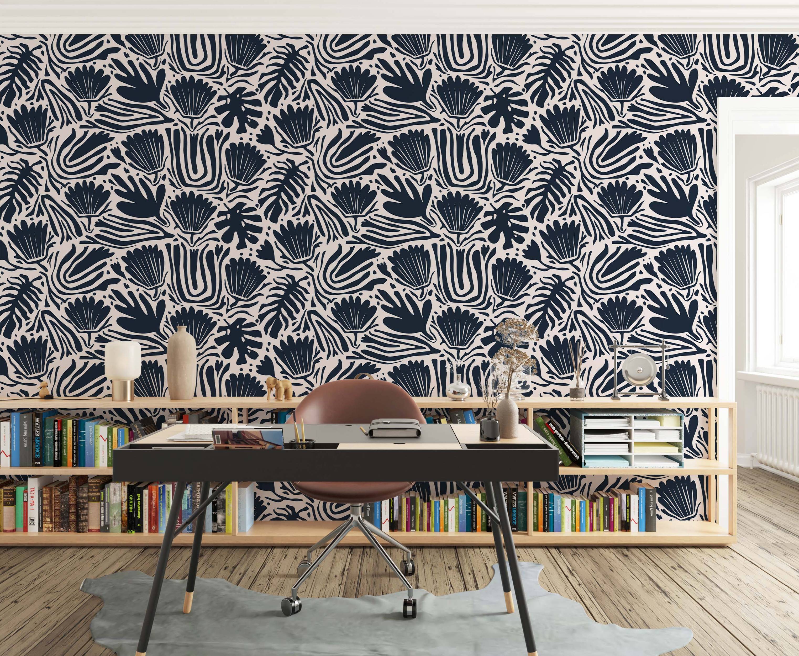 Abstract botanical wallpaper with bold navy blue stylized flowers, leaves, and wavy stripes on a light beige background.