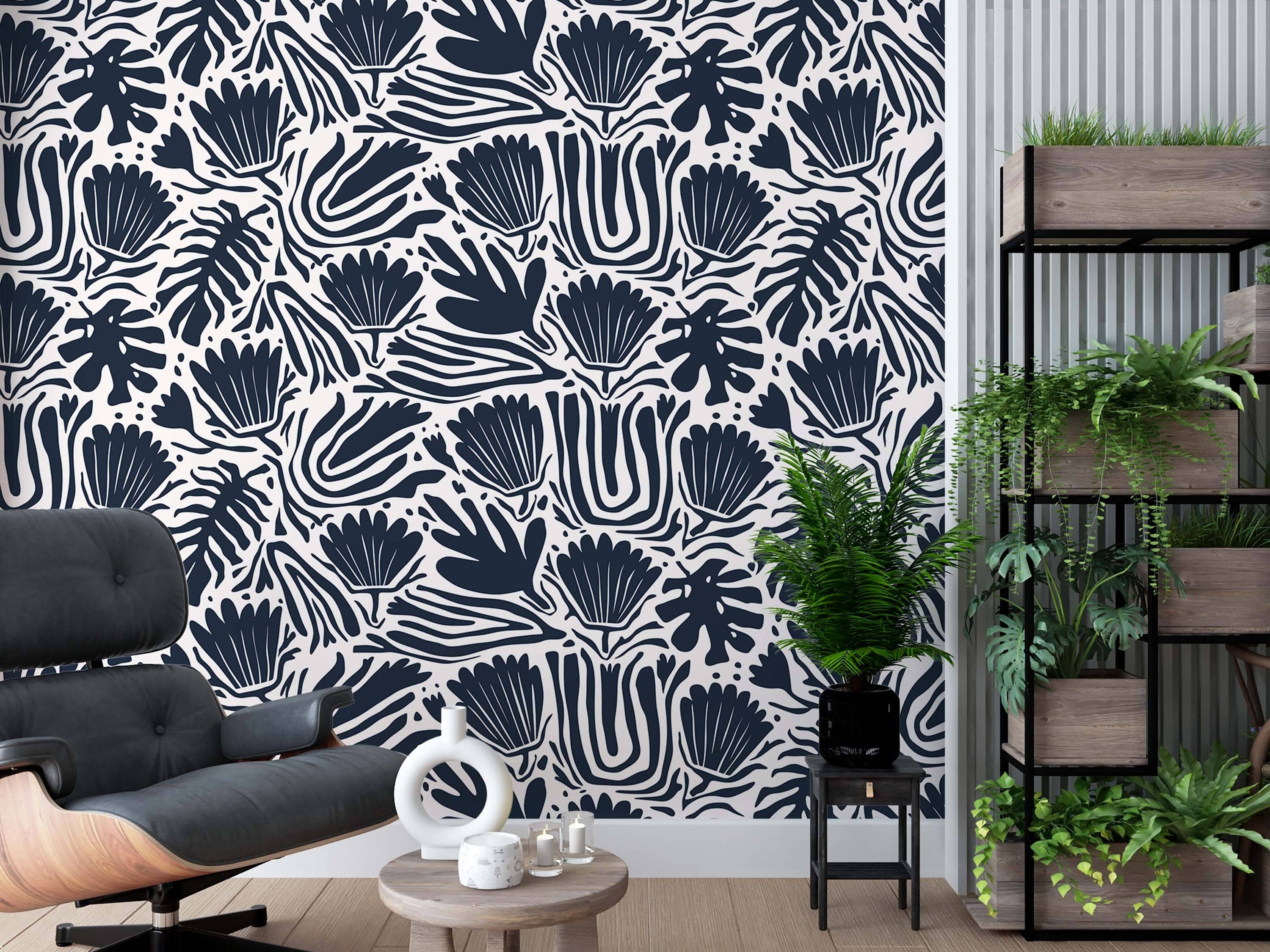 Abstract botanical wallpaper with bold navy blue leaf and flower shapes, plus wavy stripes, on an off-white background.