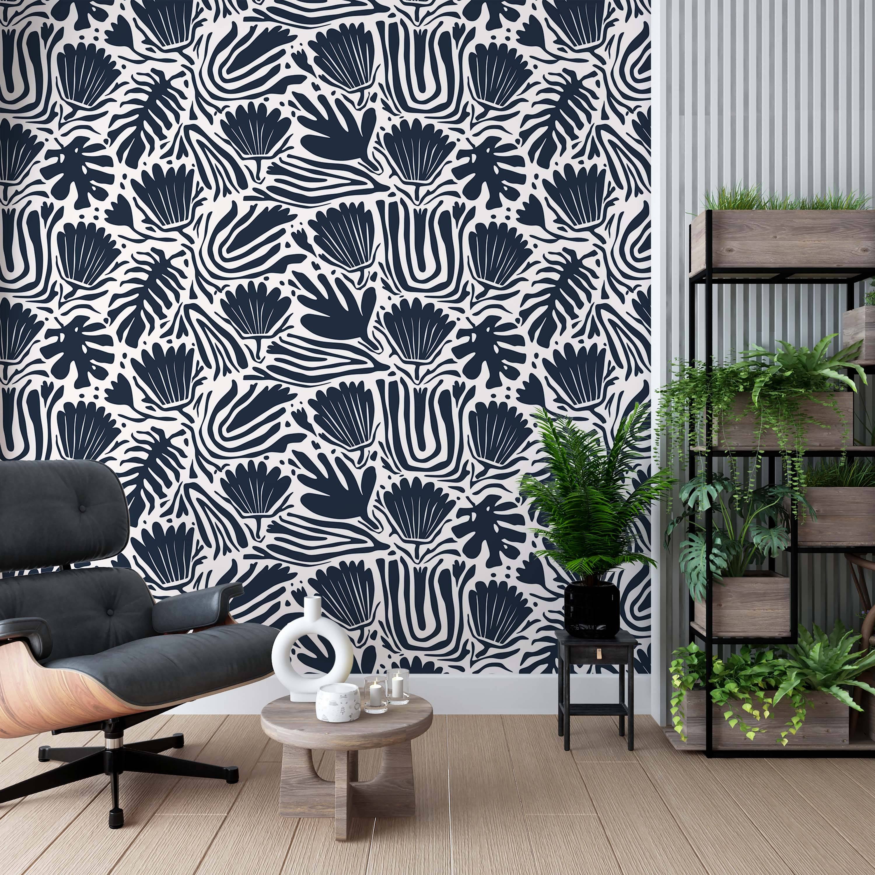 Abstract botanical wallpaper with bold navy blue leaf and flower shapes, plus wavy stripes, on an off-white background.
