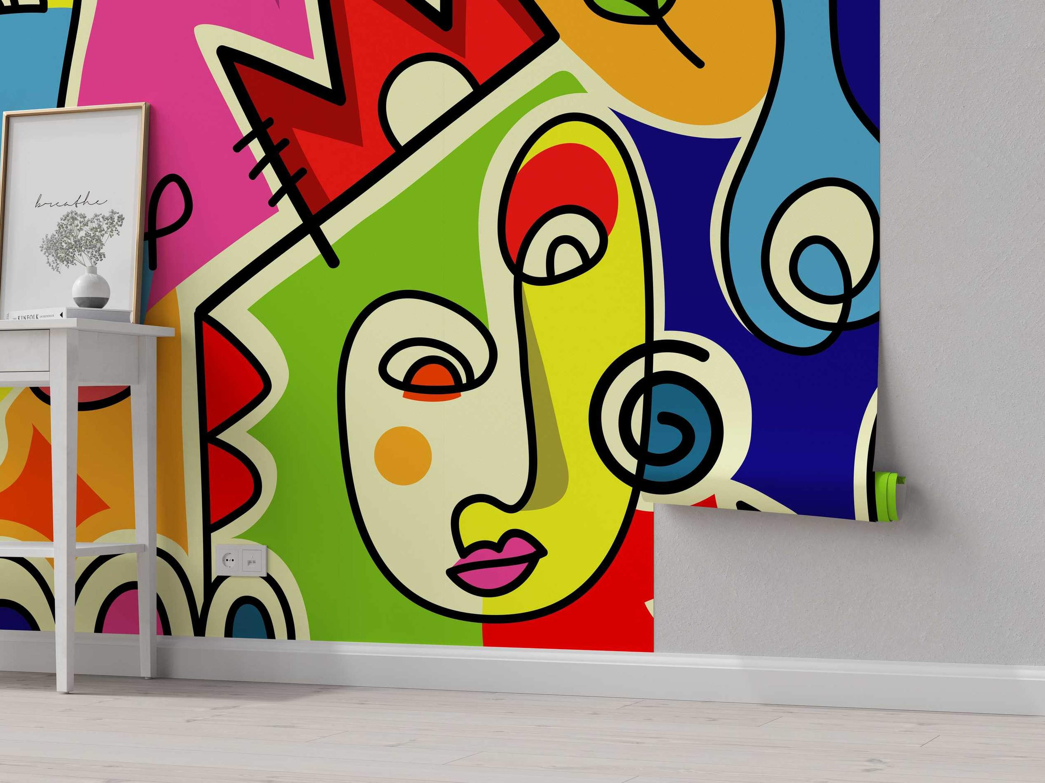 Abstract mural featuring a cubist-style face with bold geometric shapes in vibrant pink, red, green, yellow, blue, and orange, outlined in black.