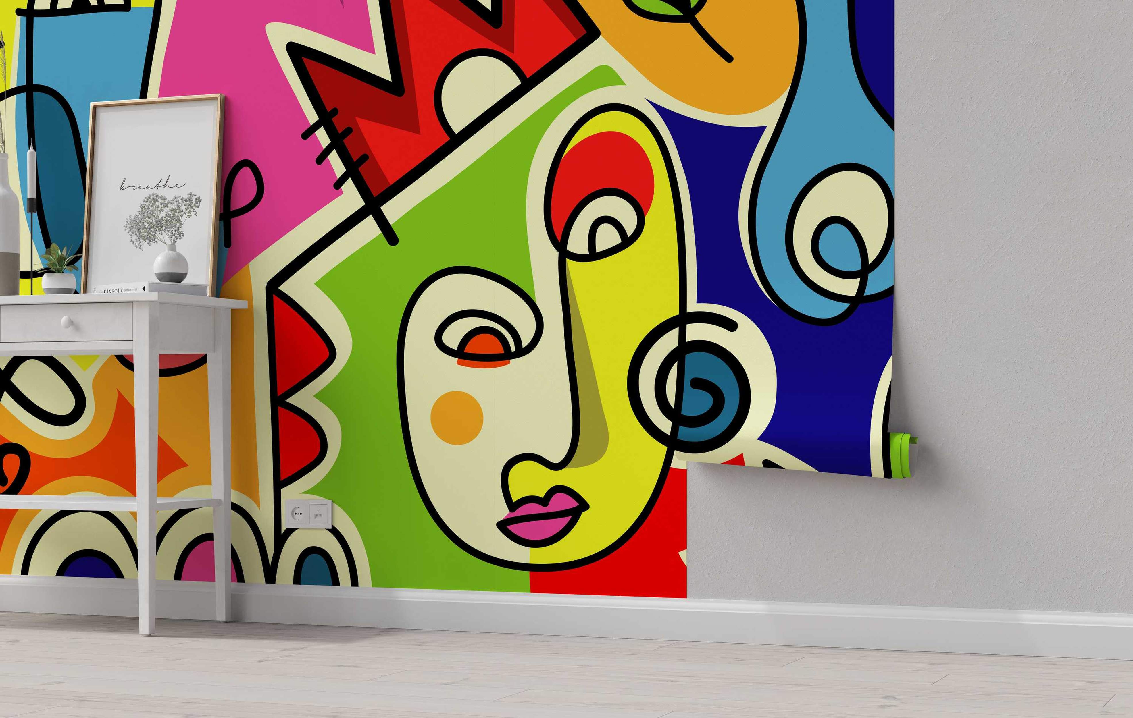 Abstract mural featuring a cubist-style face with bold geometric shapes in vibrant pink, red, green, yellow, blue, and orange, outlined in black.