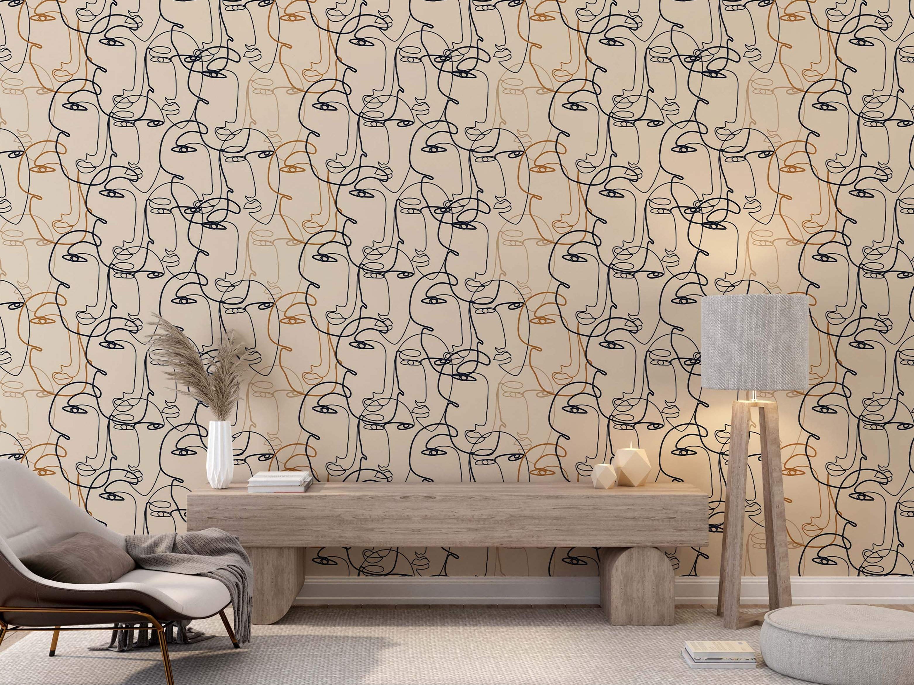 Wallpaper featuring abstract, overlapping line art faces drawn in continuous black and orange lines on a beige field.
