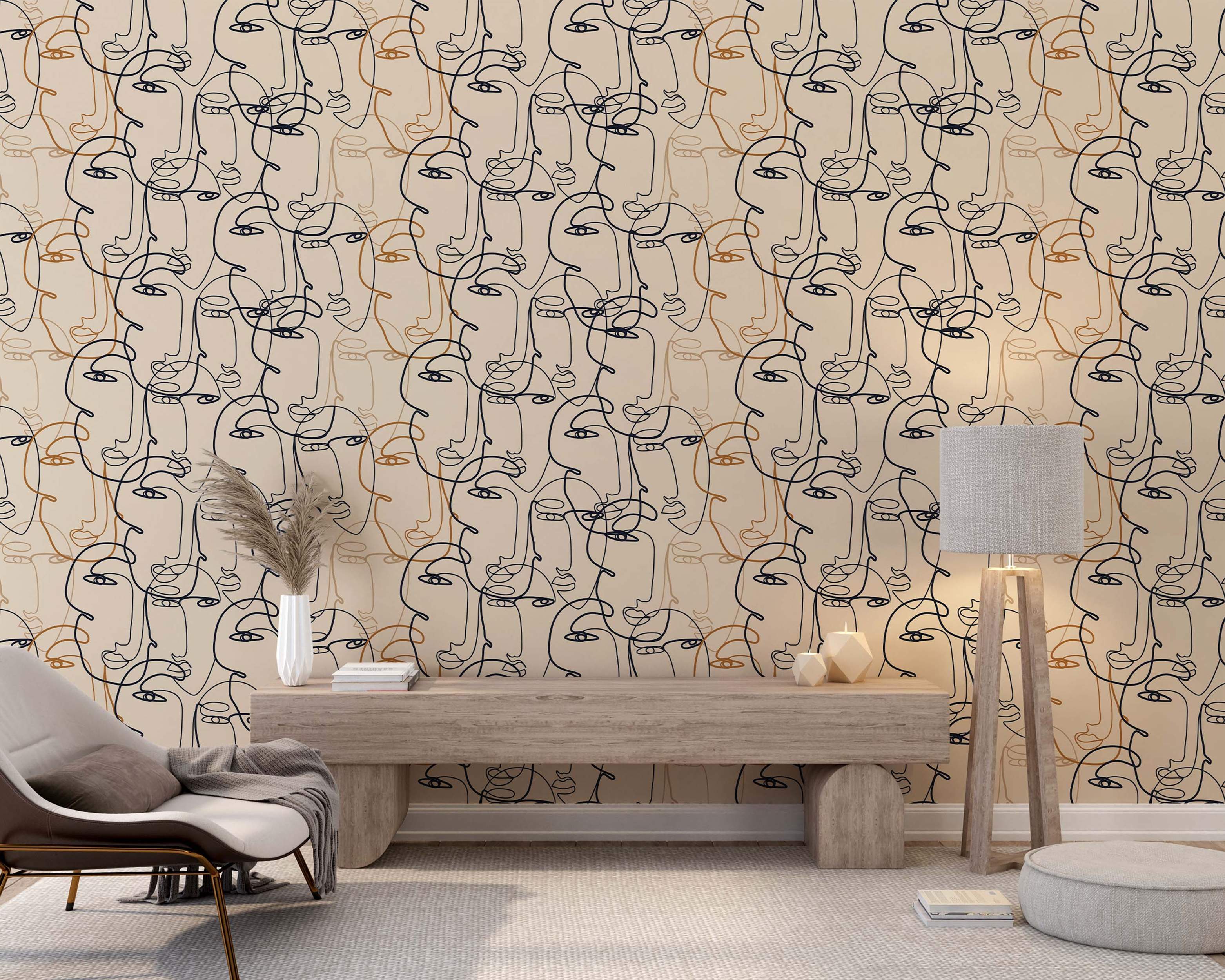 Wallpaper featuring abstract, overlapping line art faces drawn in continuous black and orange lines on a beige field.