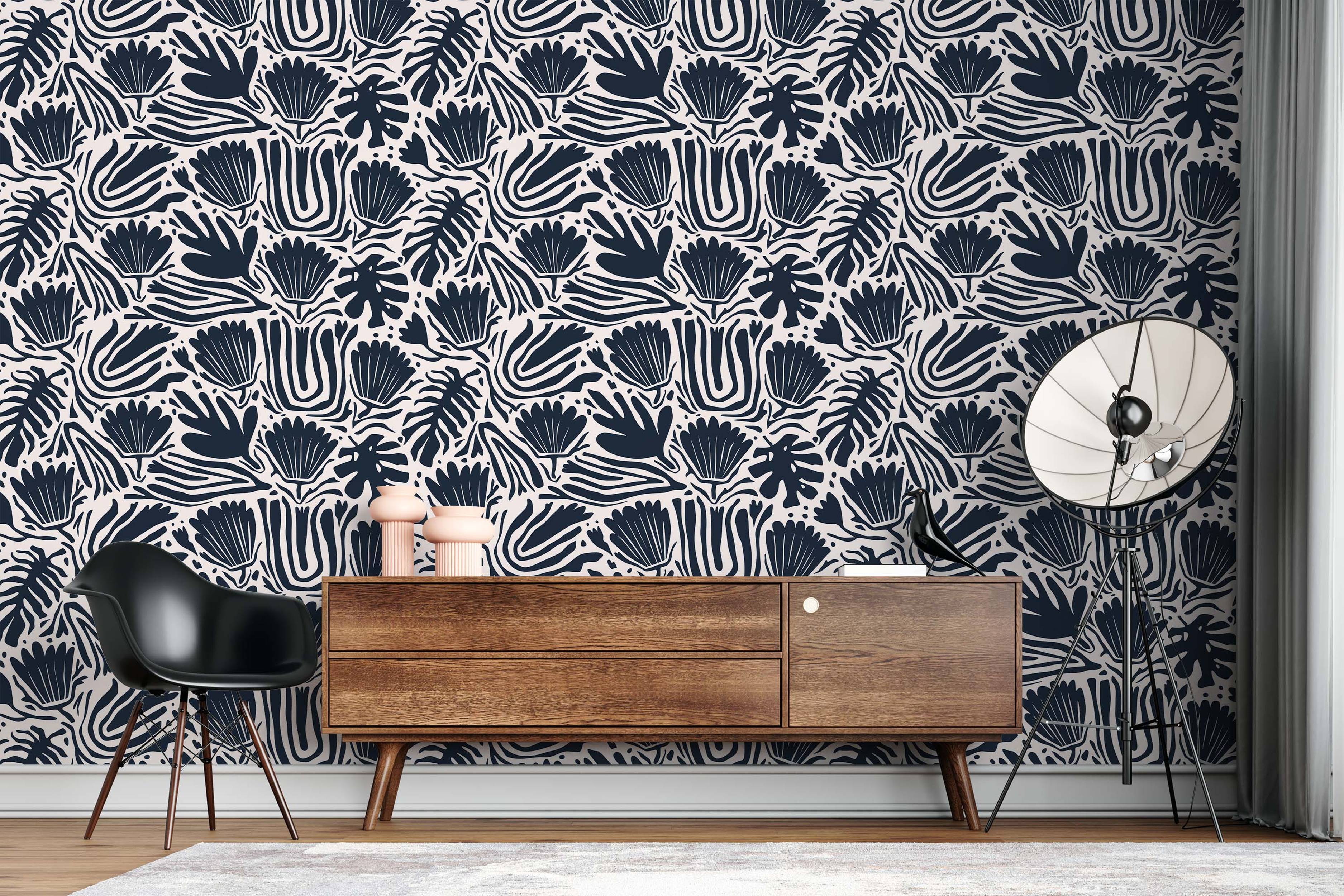 Abstract botanical wallpaper with stylized navy blue floral and leaf motifs on an off-white background.