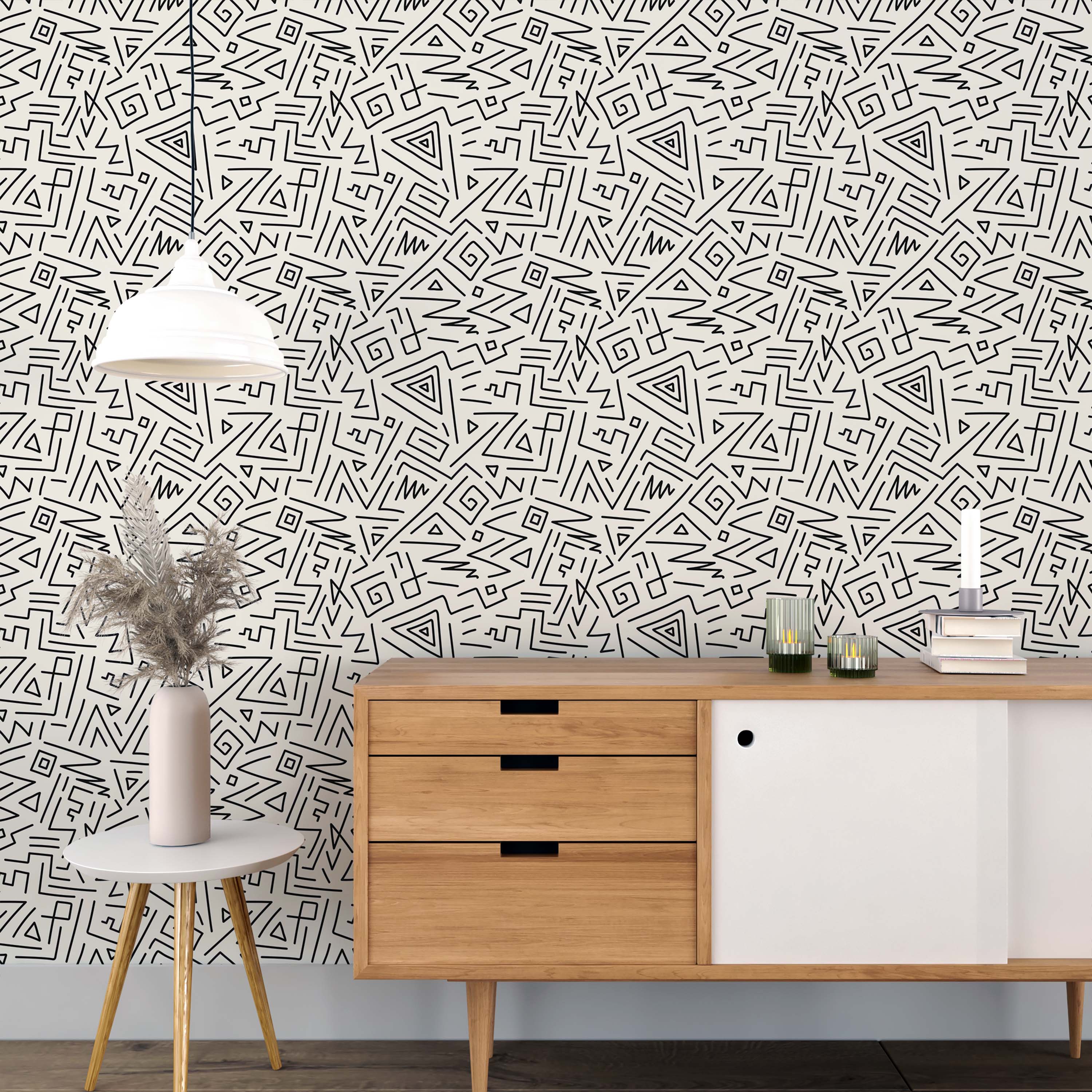 Wallpaper with an abstract geometric pattern of hand-drawn black lines, triangles, and spirals on a cream background.