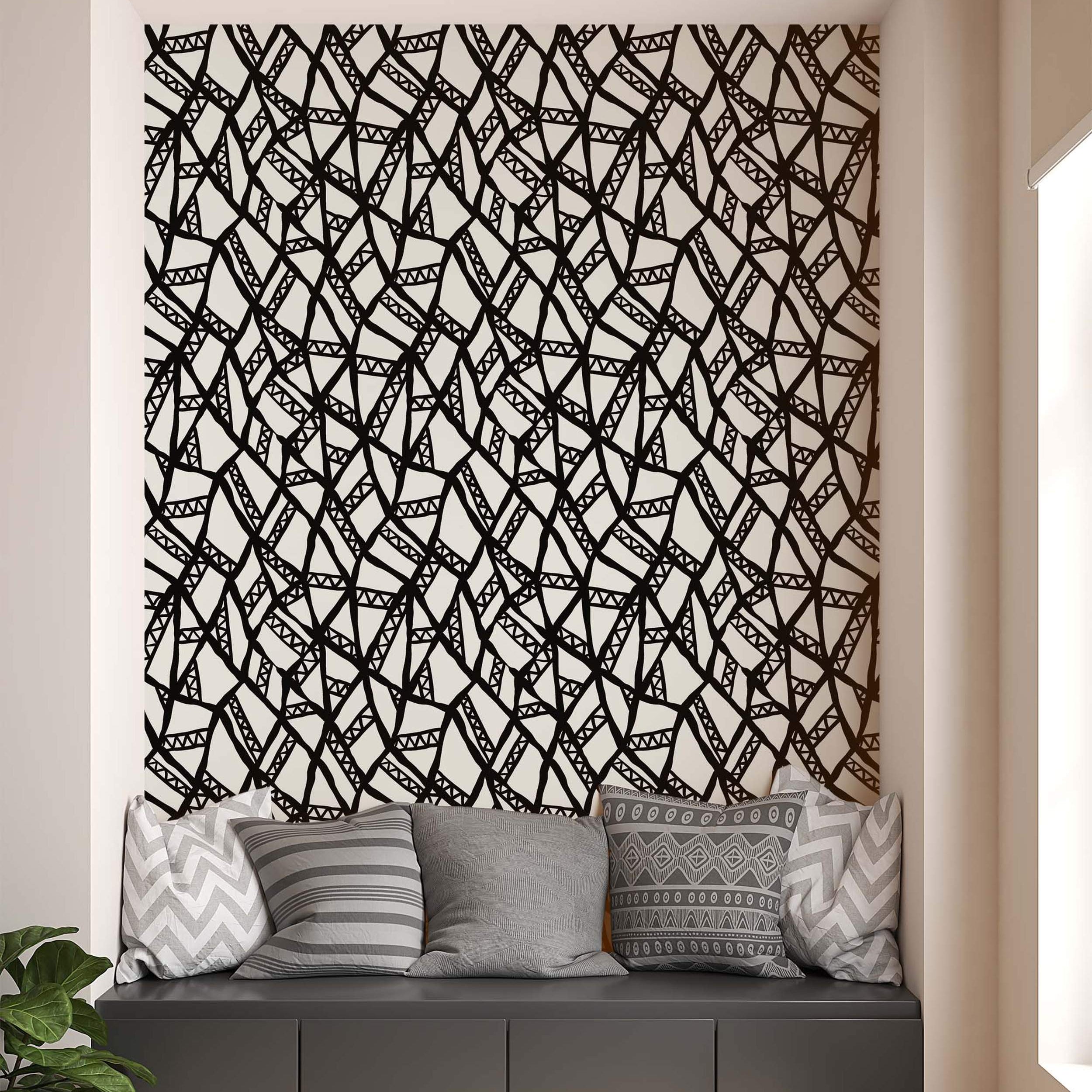 Abstract geometric wallpaper with bold, hand-drawn black lines forming irregular shapes and triangles on a white background.