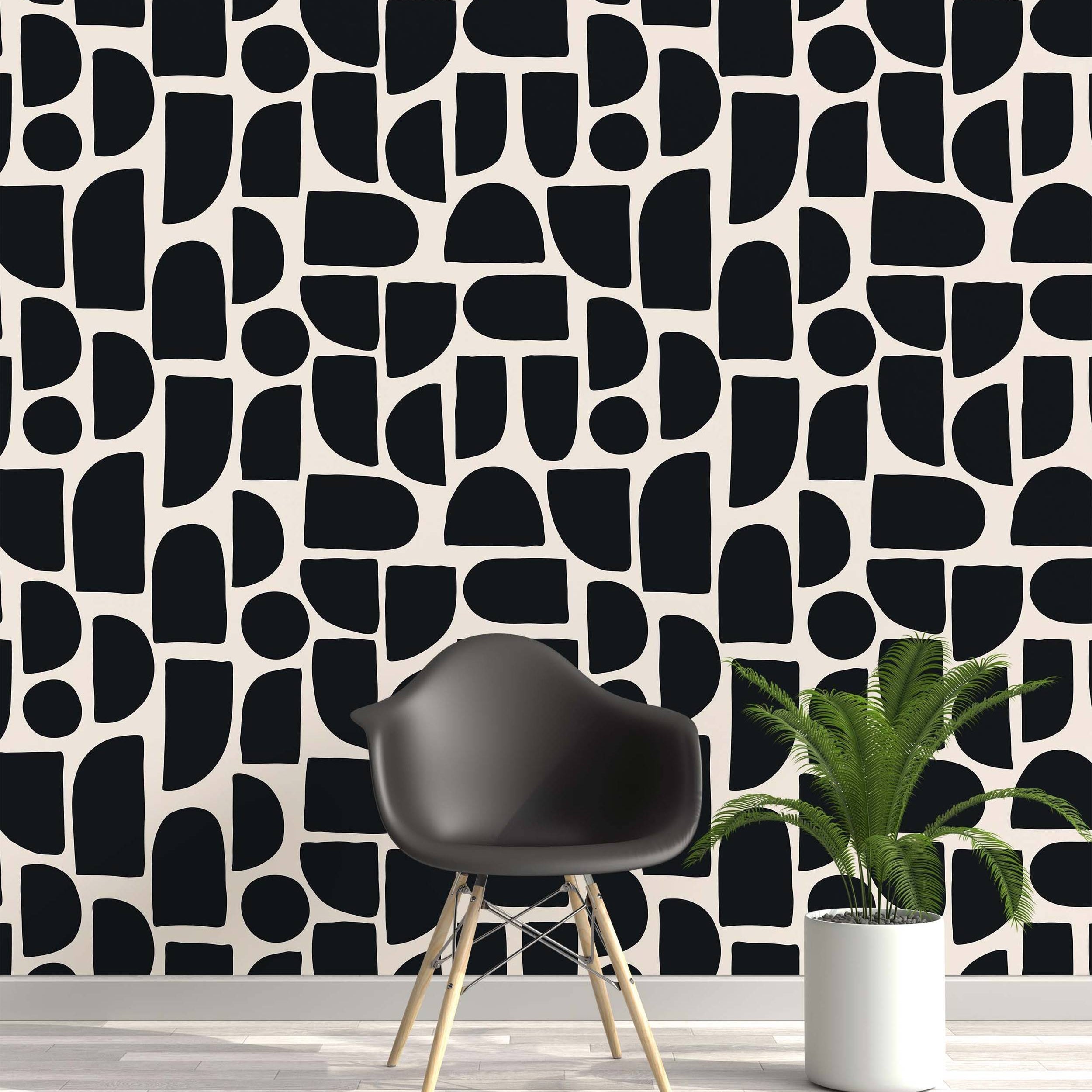 Wallpaper featuring an abstract pattern of bold, black geometric shapes with rounded corners on a cream background.