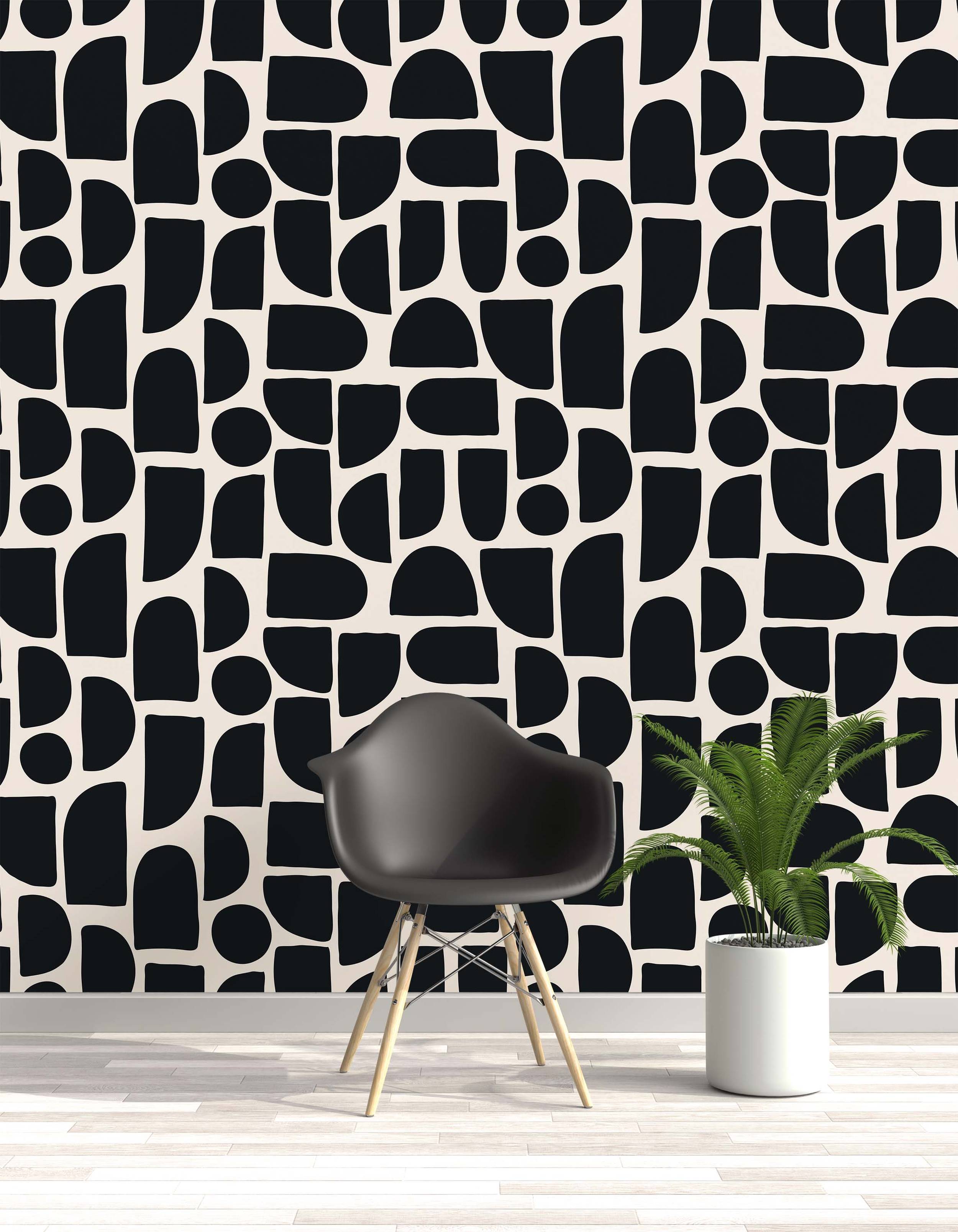 Wallpaper featuring an abstract pattern of bold, black geometric shapes with rounded corners on a cream background.