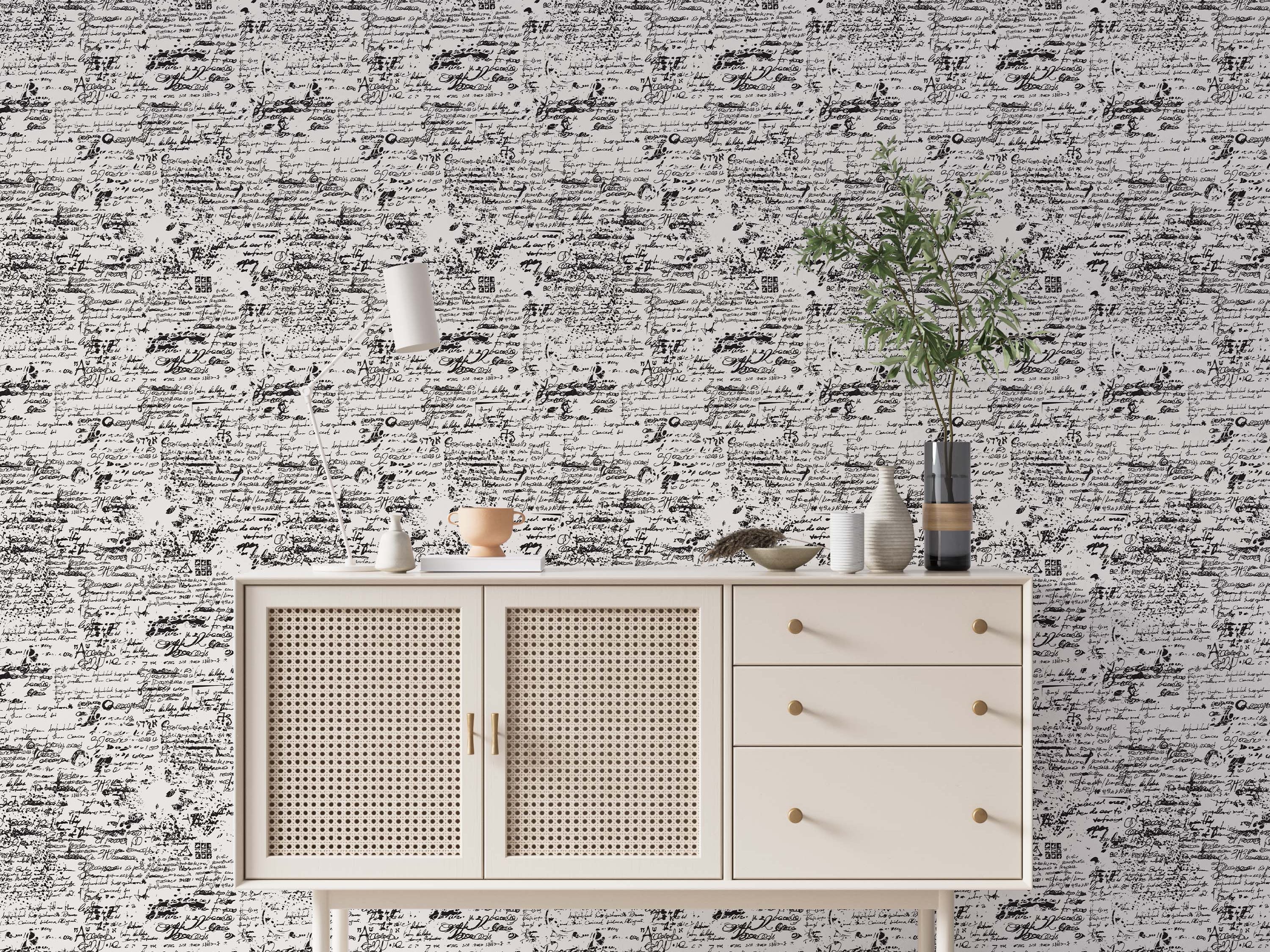 Abstract wallpaper with a repeating pattern of layered, distressed black handwritten script on a white background.