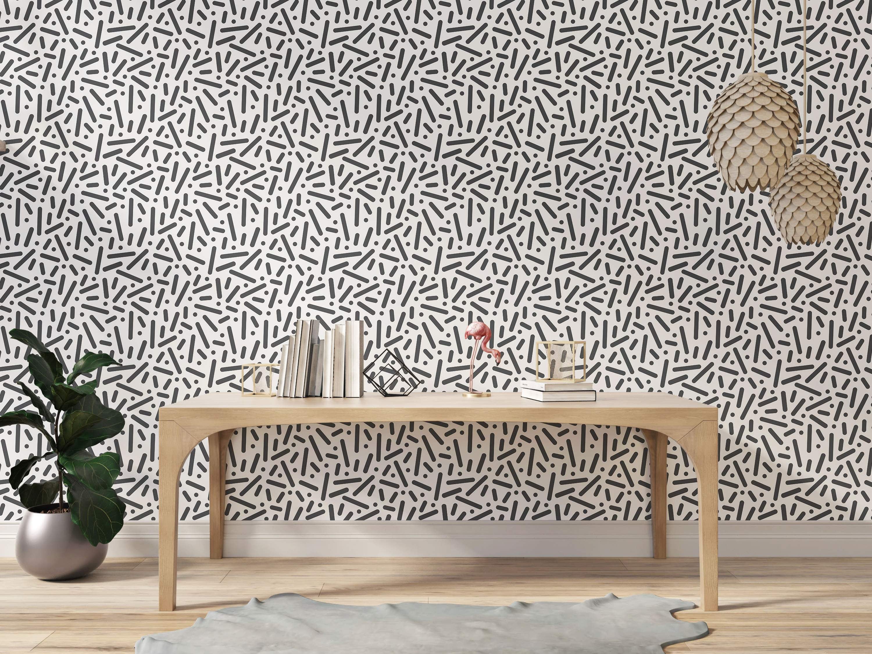 Wallpaper featuring a scattered abstract pattern of dark gray rounded lines and dots on a white background.