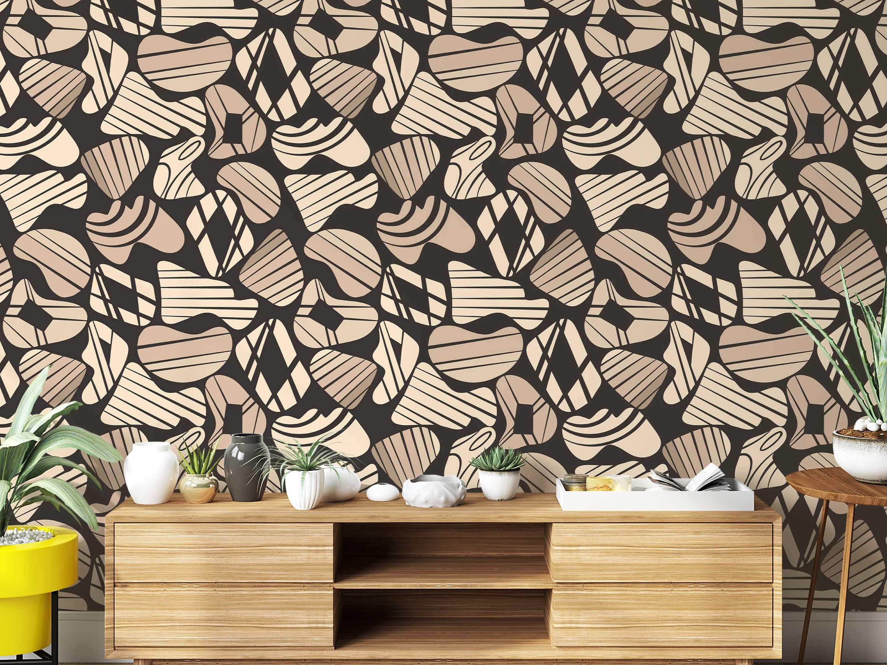 Abstract wallpaper with organic, rounded shapes in beige and tan featuring striped and diamond patterns on a dark brown background.