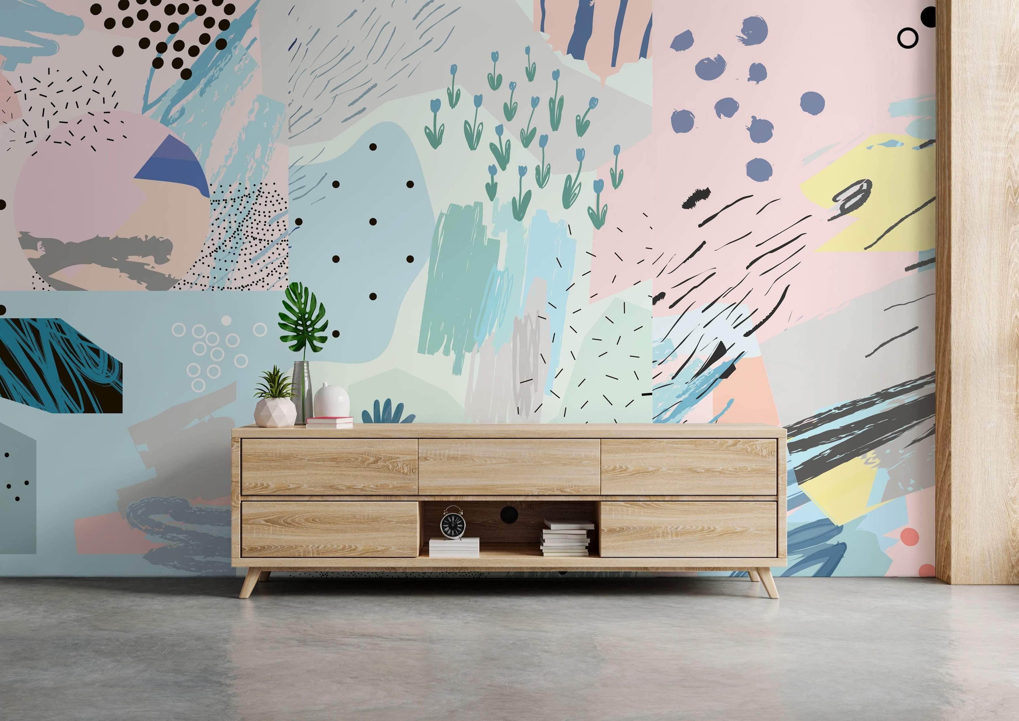 Abstract collage mural with blocks of pastel colors, black dots, lines, brushstrokes, and simple blue flower drawings.
