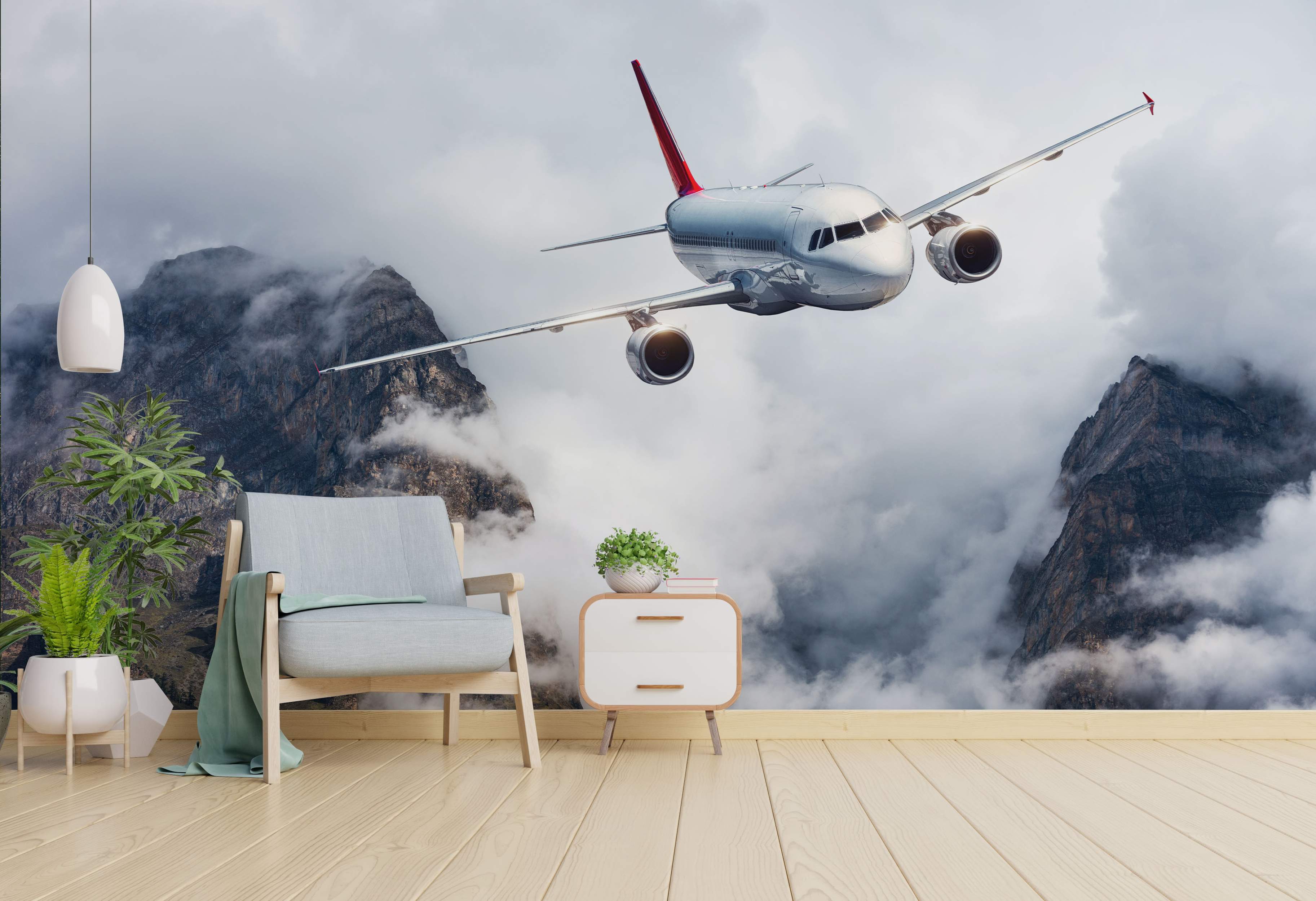 A realistic mural depicts a silver passenger airplane with a red tail flying low through misty gray mountains and clouds.