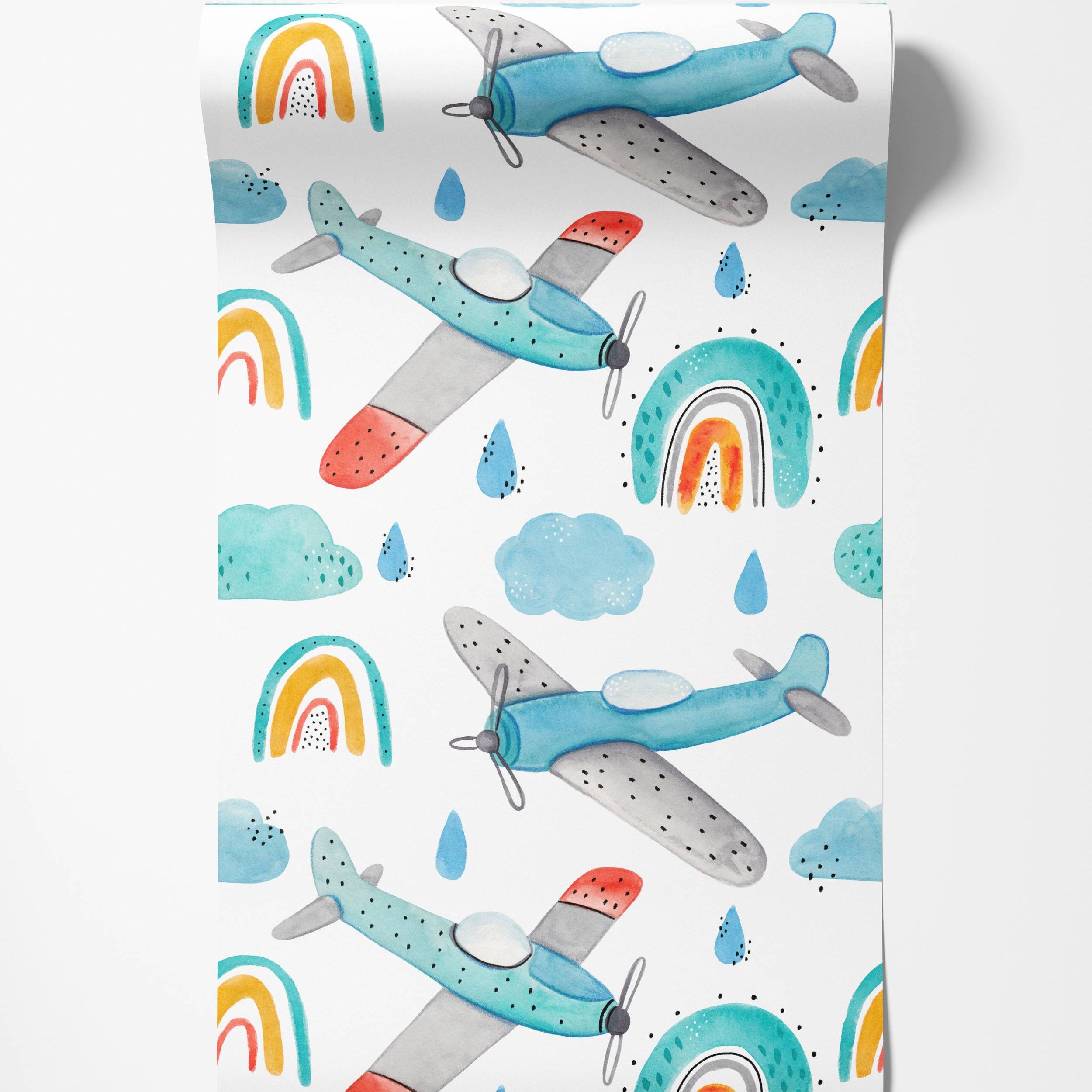 Watercolor wallpaper featuring blue and grey airplanes with red accents, teal-yellow-red rainbows, blue clouds, and raindrops.