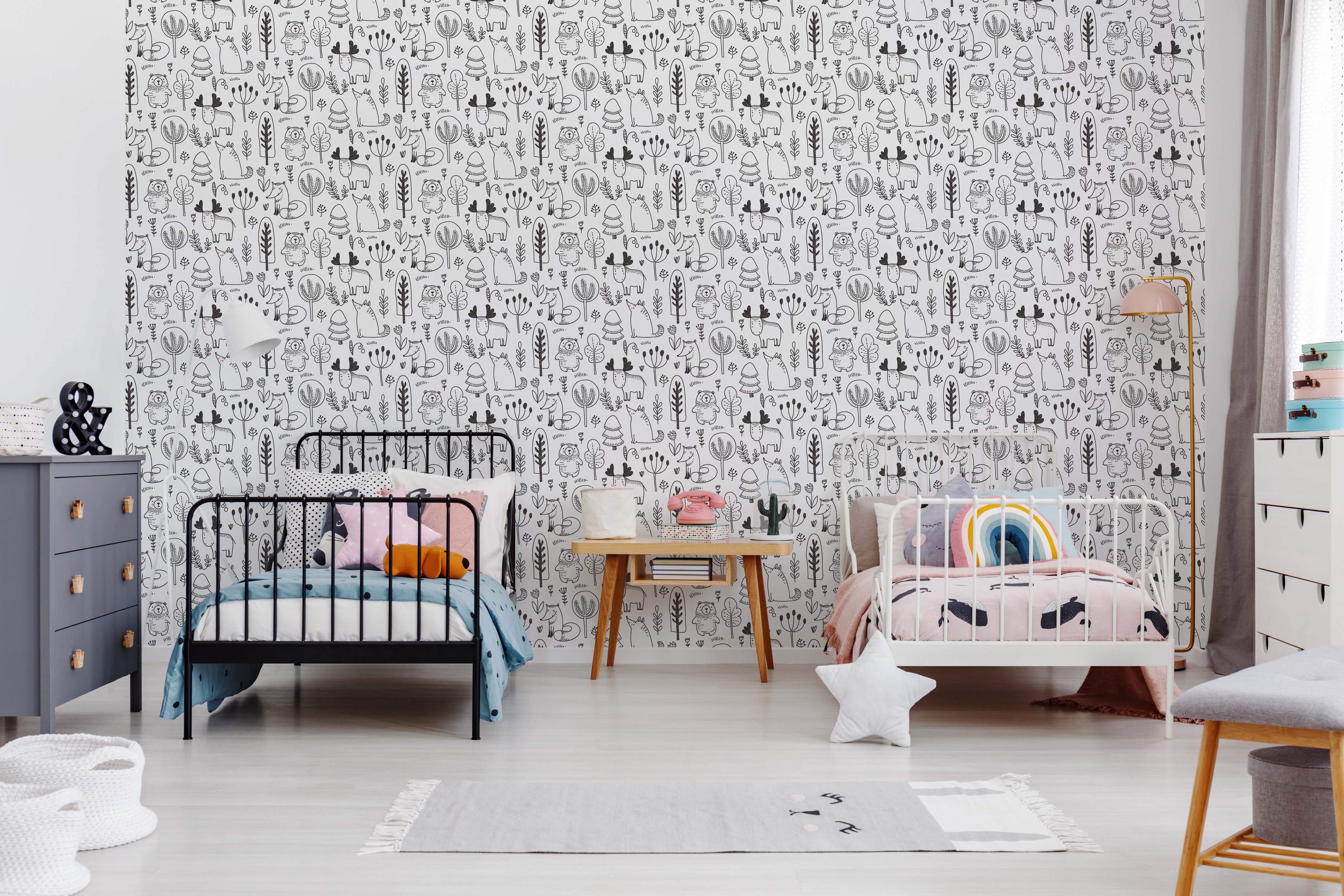 Wallpaper features a repeating pattern of black hand-drawn woodland animals like foxes, bears, and moose among trees on white.