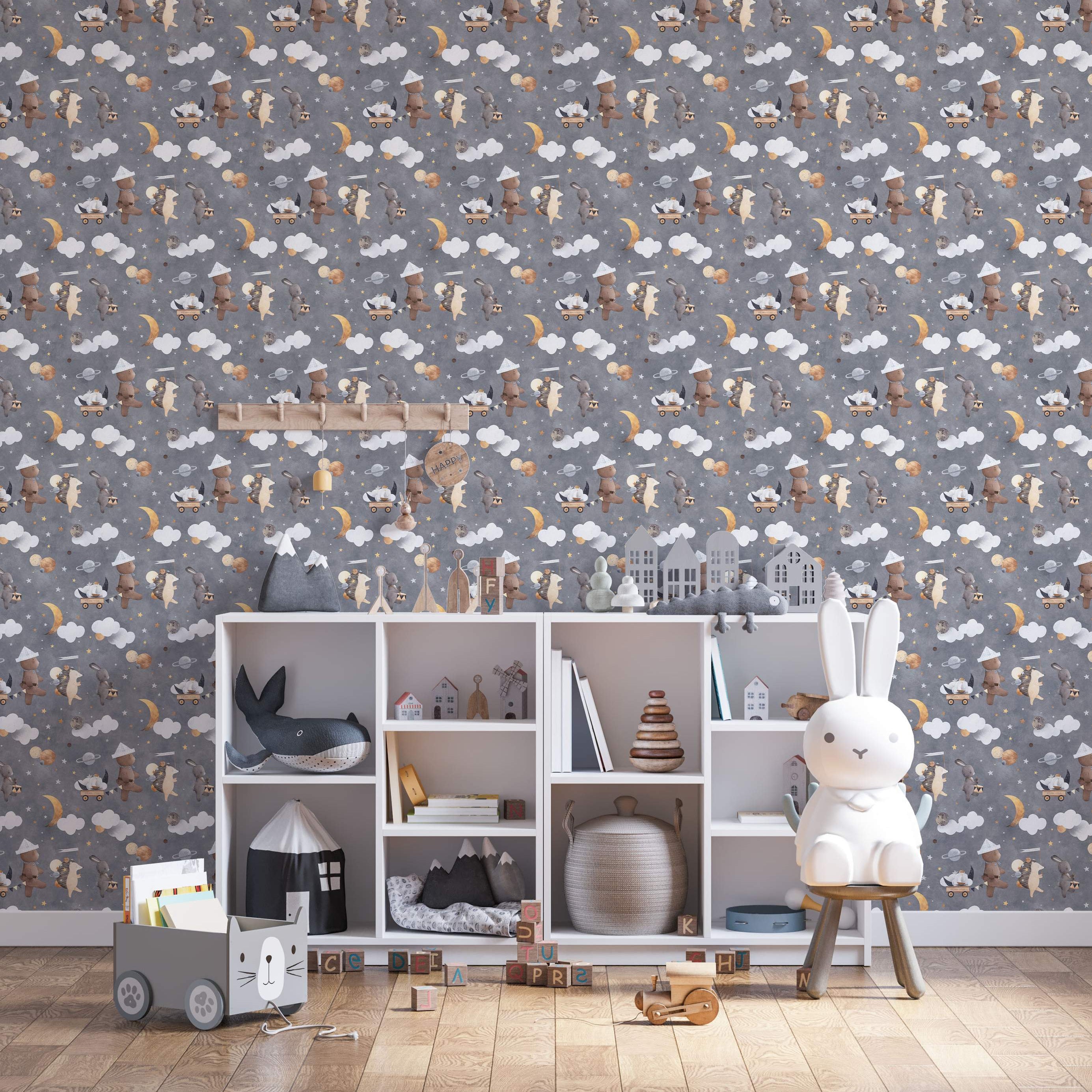 Kids wallpaper with repeating pattern of illustrated bears, rabbits, and hedgehogs amongst clouds, stars, moons, and planets on gray.