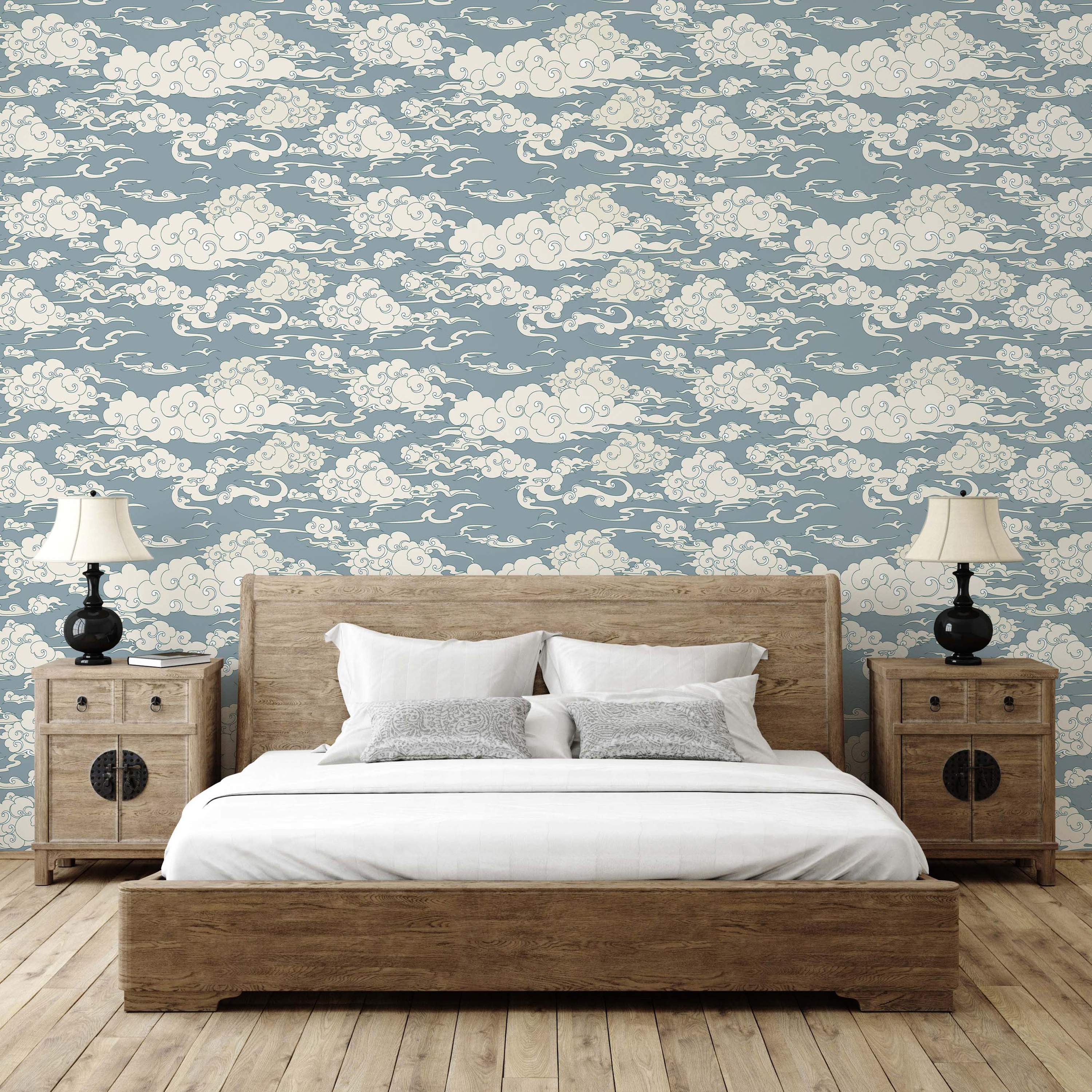 Wallpaper featuring traditional Asian-style swirling clouds in cream with blue outlines on a dusty blue background.