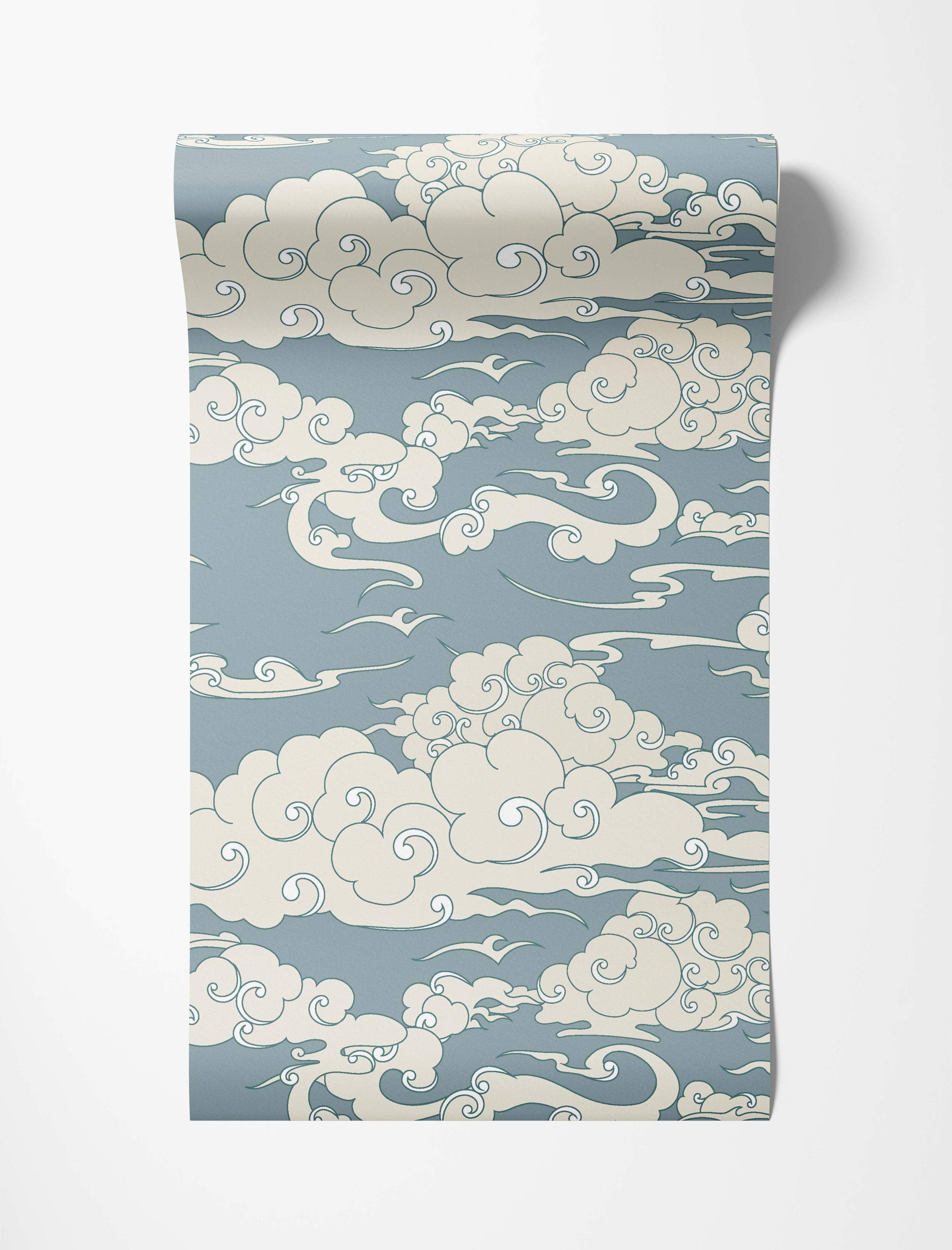 Stylized East Asian cloud wallpaper with swirling cream clouds outlined in dark blue against a dusty blue background.