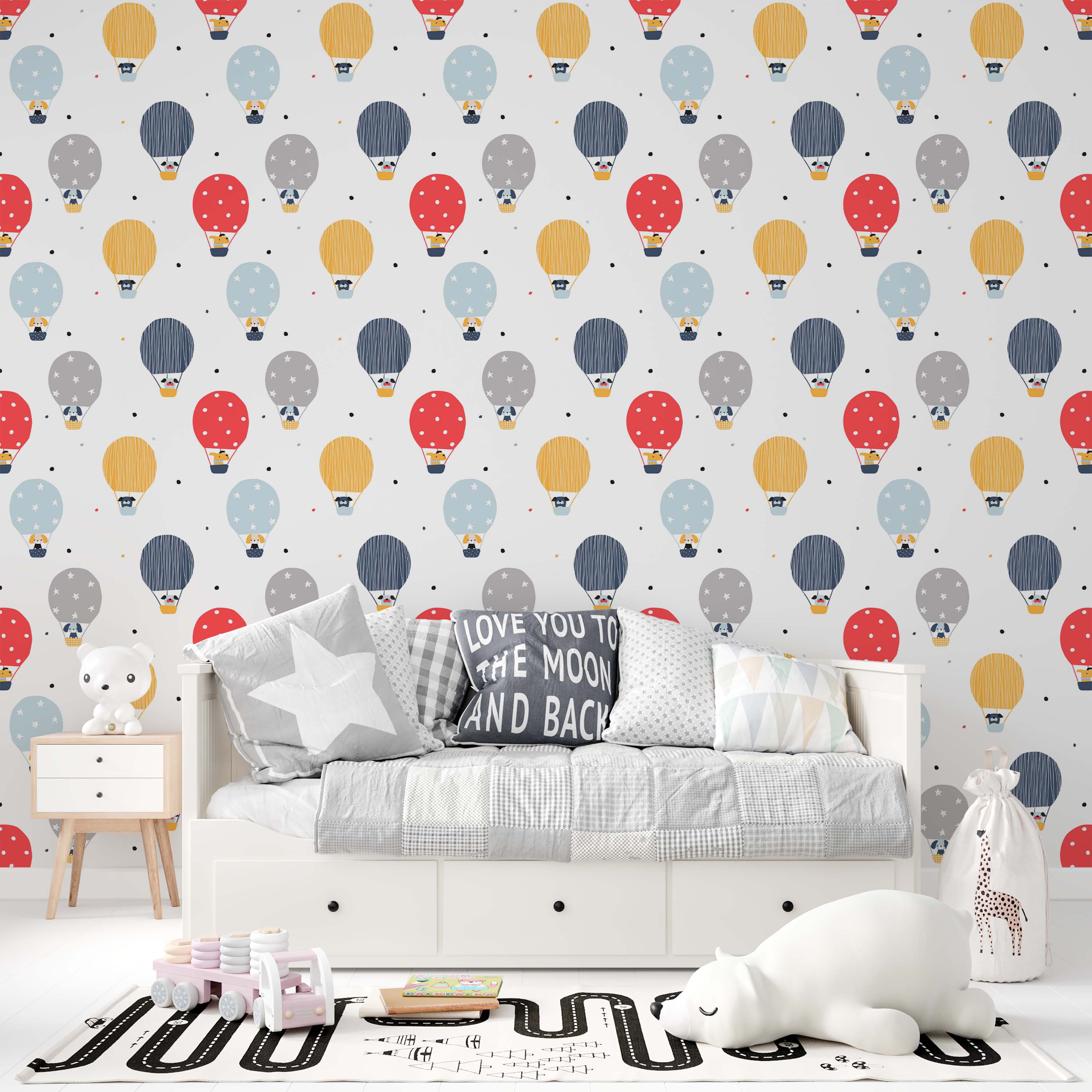 Wallpaper with red, yellow, blue, and gray hot air balloons carrying dogs. Balloons show dots, stripes, or stars. White background.