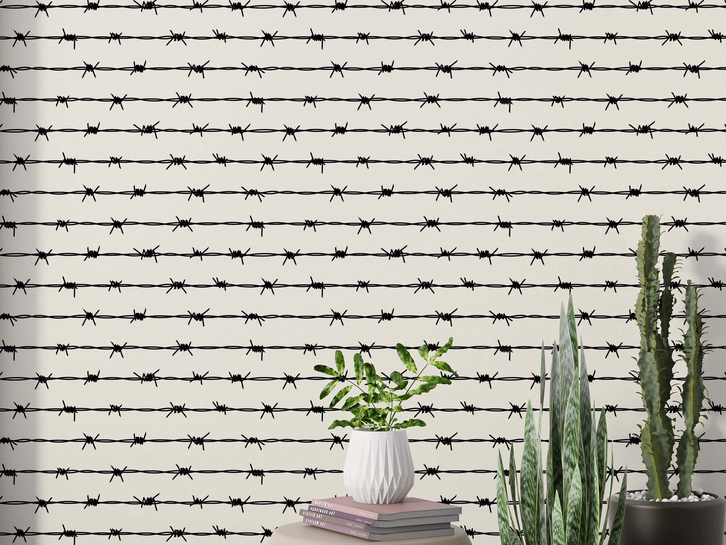 Wallpaper with horizontal lines of black barbed wire on a cream background.