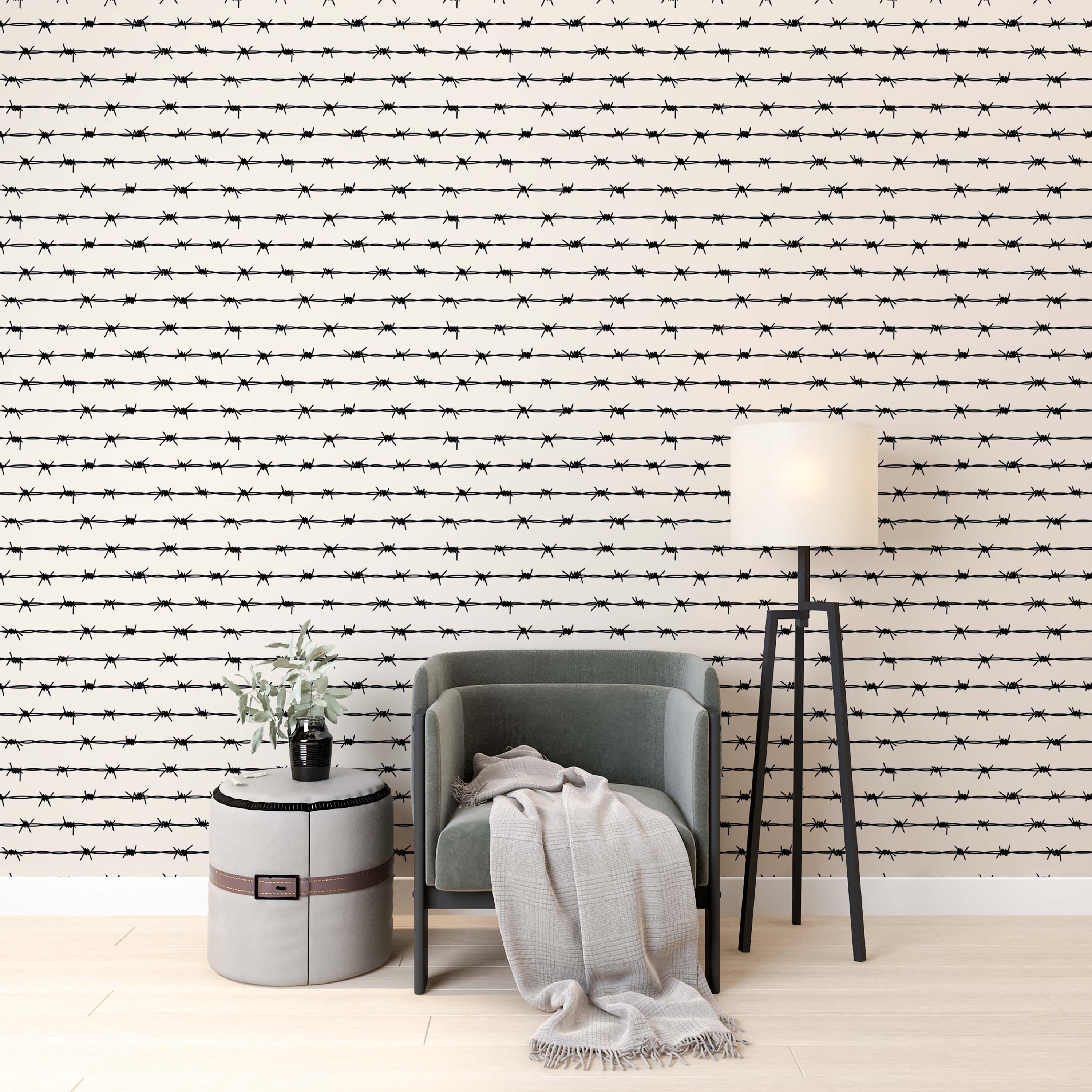 Wallpaper with a repeating pattern of horizontal black barbed wire strands on a light cream background.