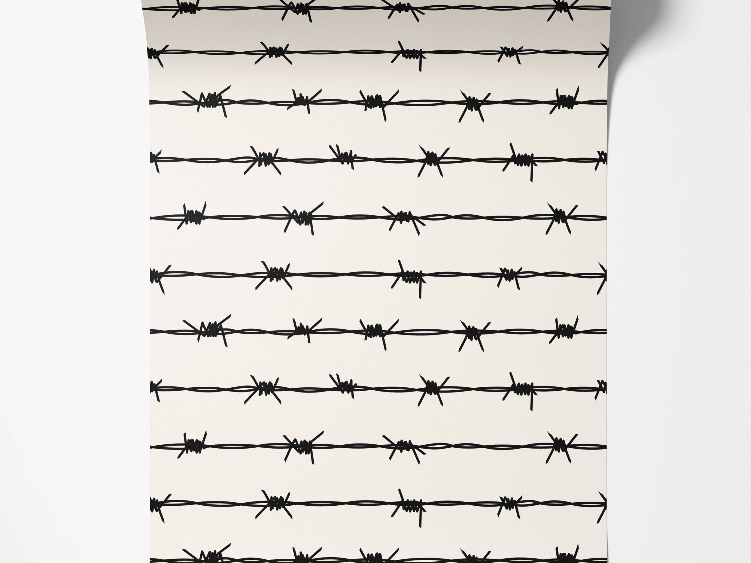 Wallpaper featuring a repeating pattern of black barbed wire strands on an off-white background.