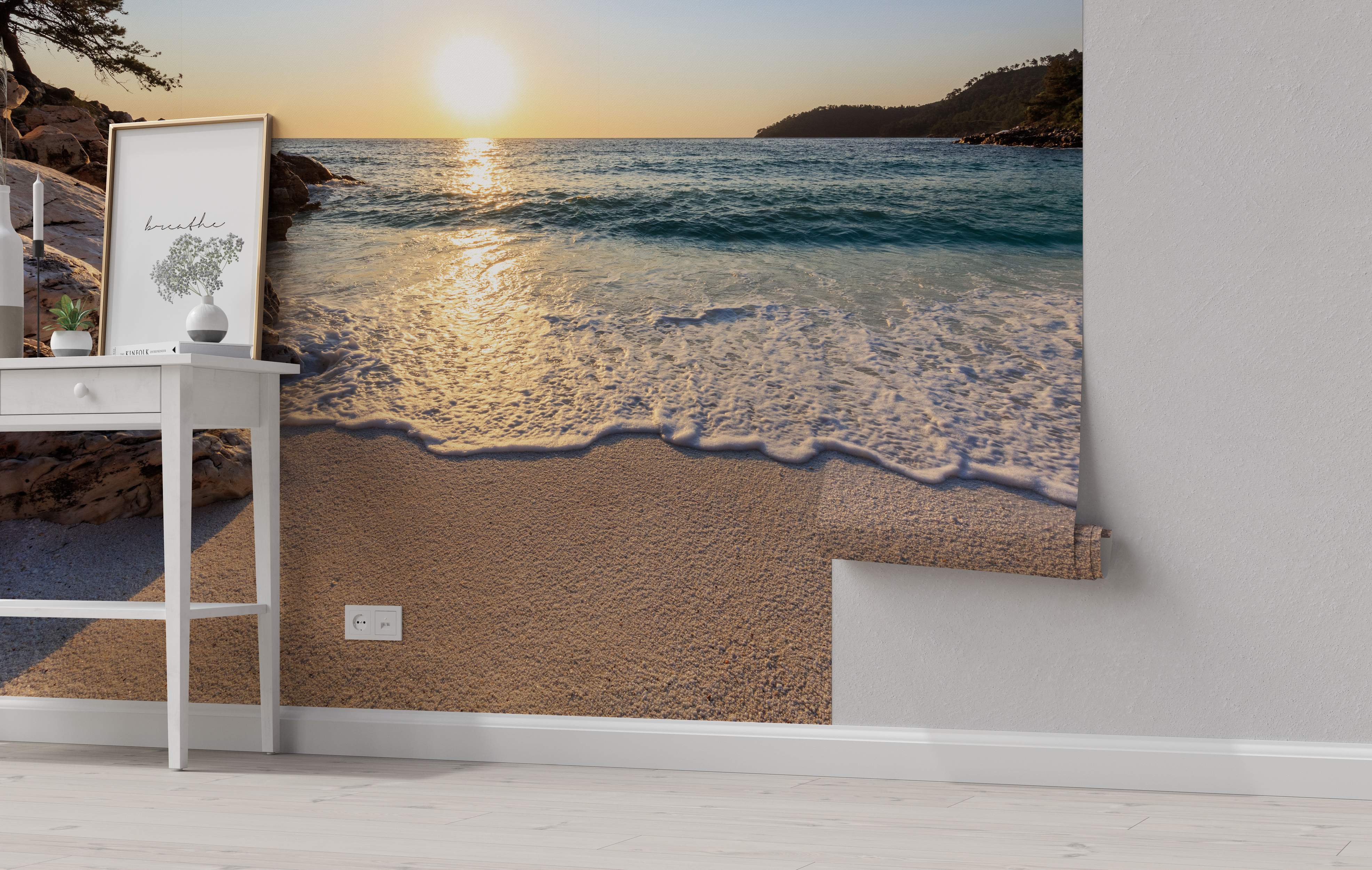 Photographic wall mural showing a golden sunset over a blue ocean with waves washing onto a sandy beach.