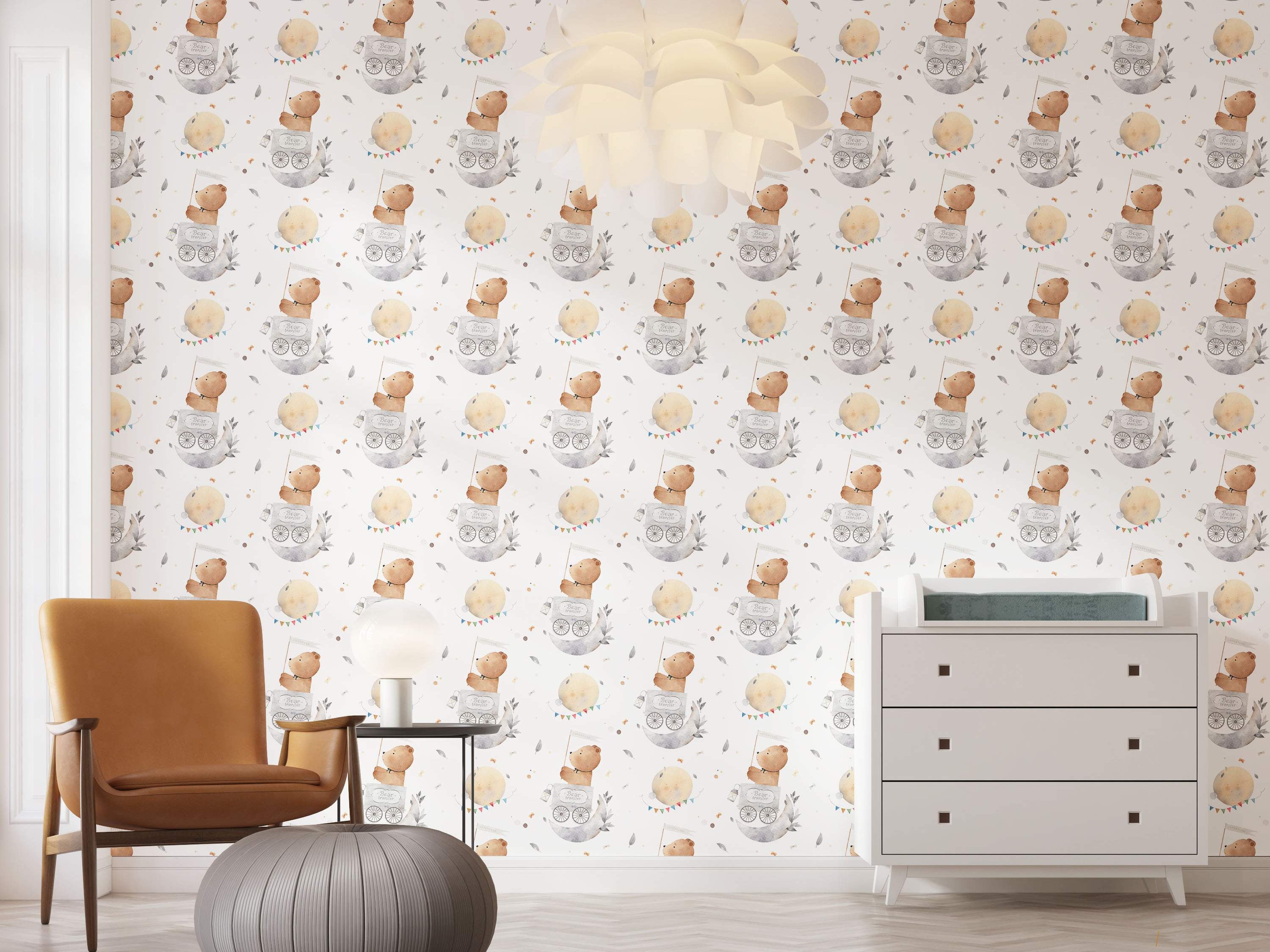 Watercolor wallpaper featuring a repeating pattern of brown bears in grey moon carts, yellow moons with bunting, and grey feathers.