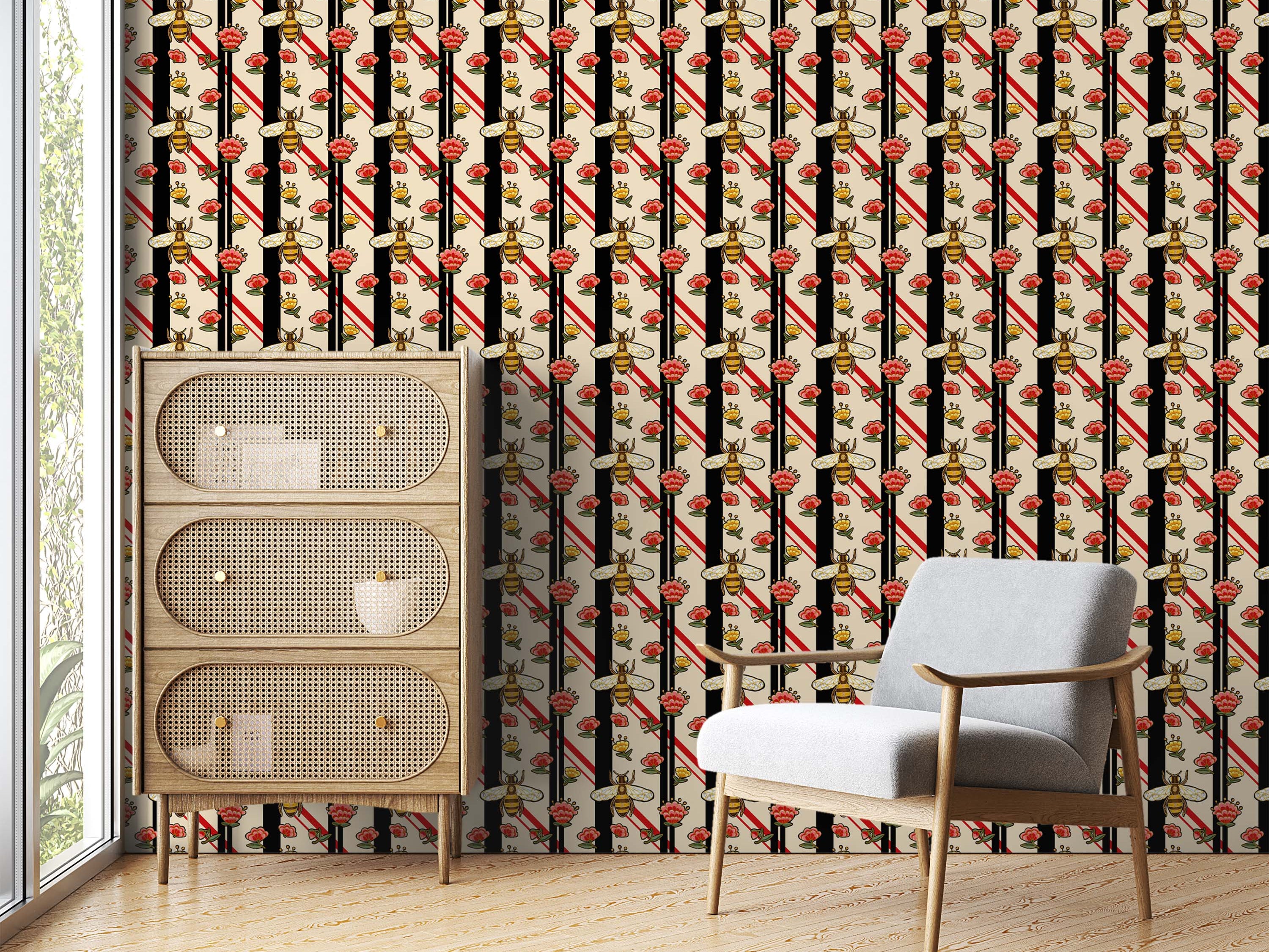Wallpaper with vertical black and red stripes, featuring a repeating pattern of illustrated bees and colorful floral motifs.