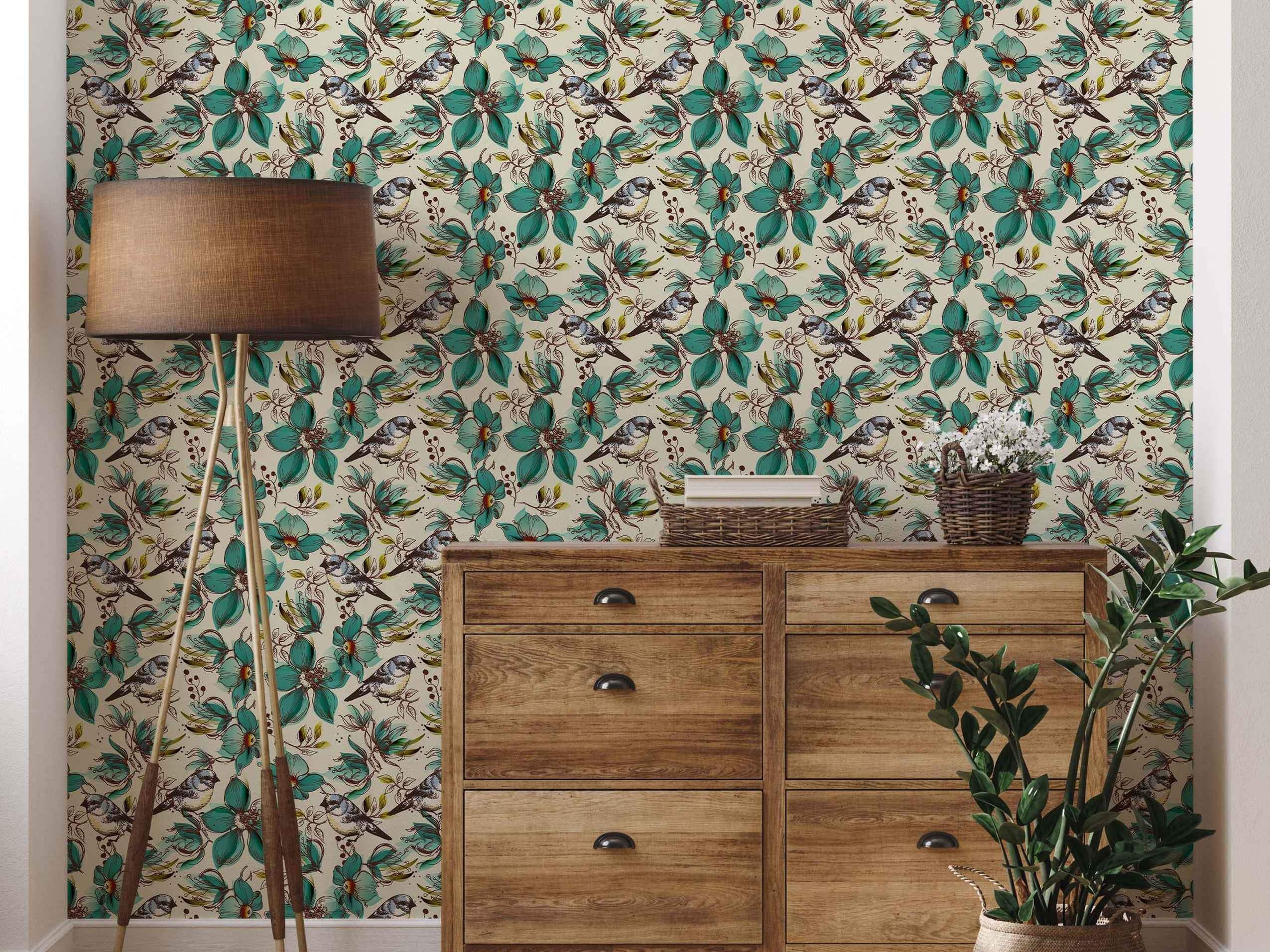 Wallpaper featuring illustrated blue tit birds perched among large teal flowers and sketched foliage on a cream background.
