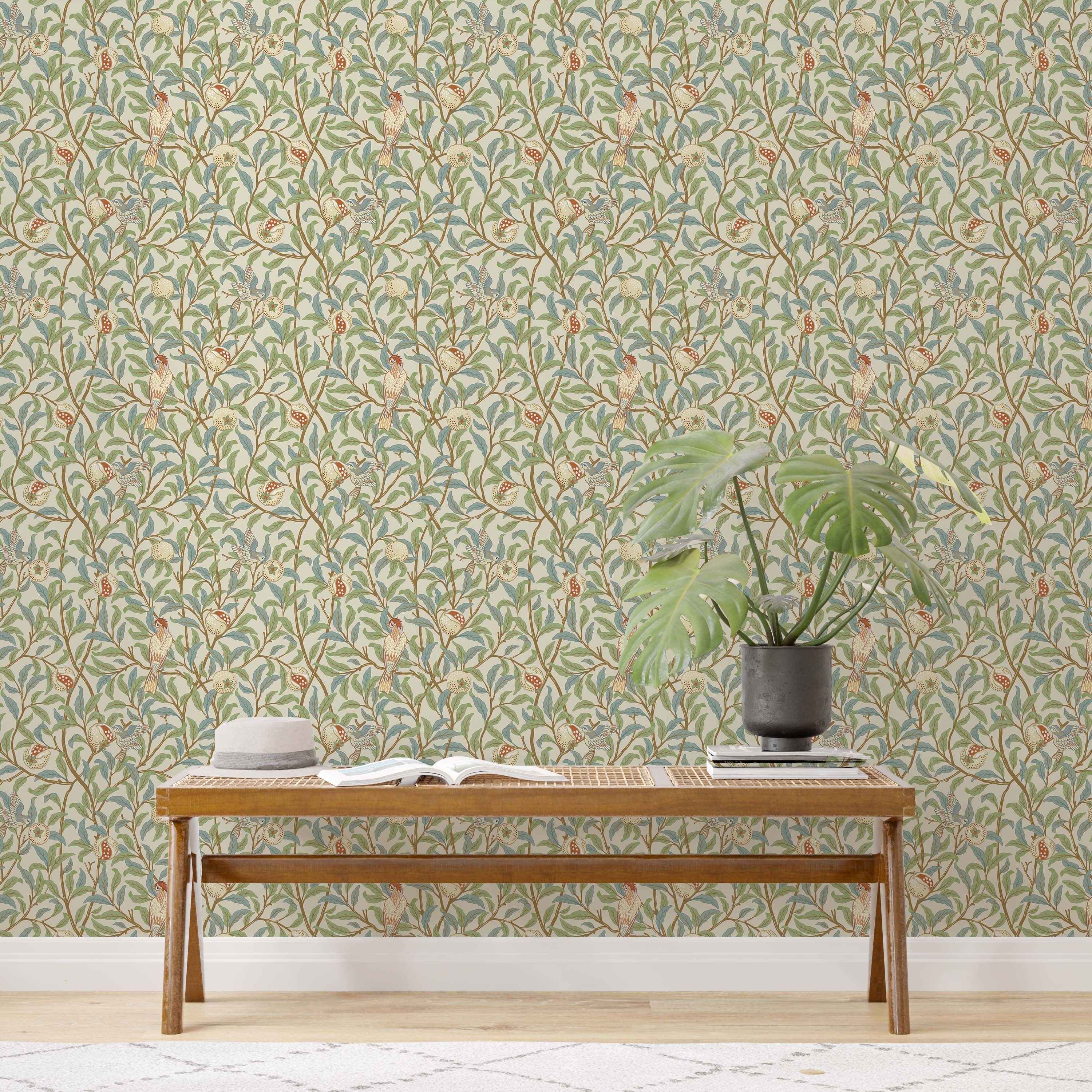 Arts and Crafts style wallpaper with birds and pomegranates on winding branches with green and blue leaves on a cream field.