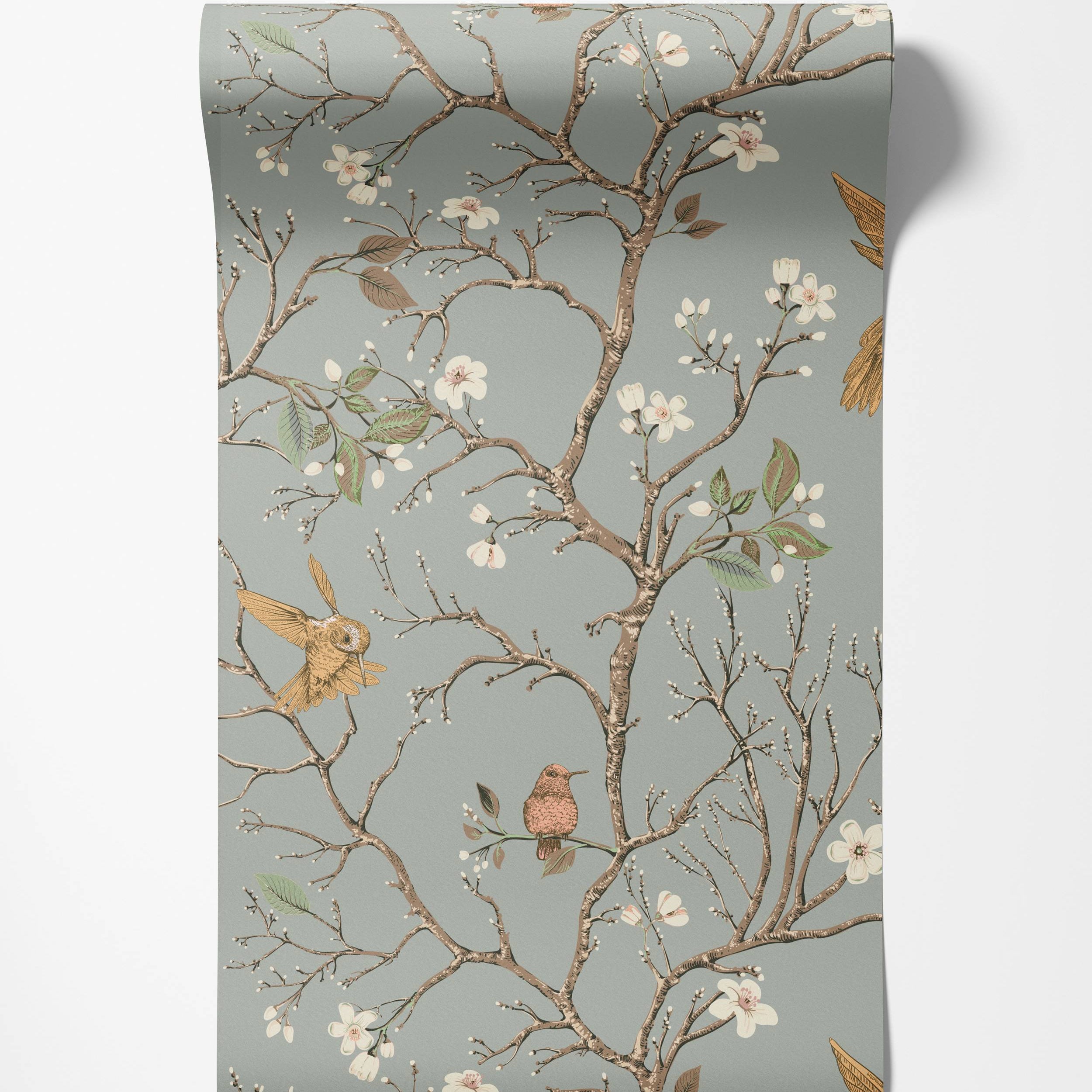 A Chinoiserie-style wallpaper with birds and blossoming branches in brown, pink, and yellow on a gray-blue background.