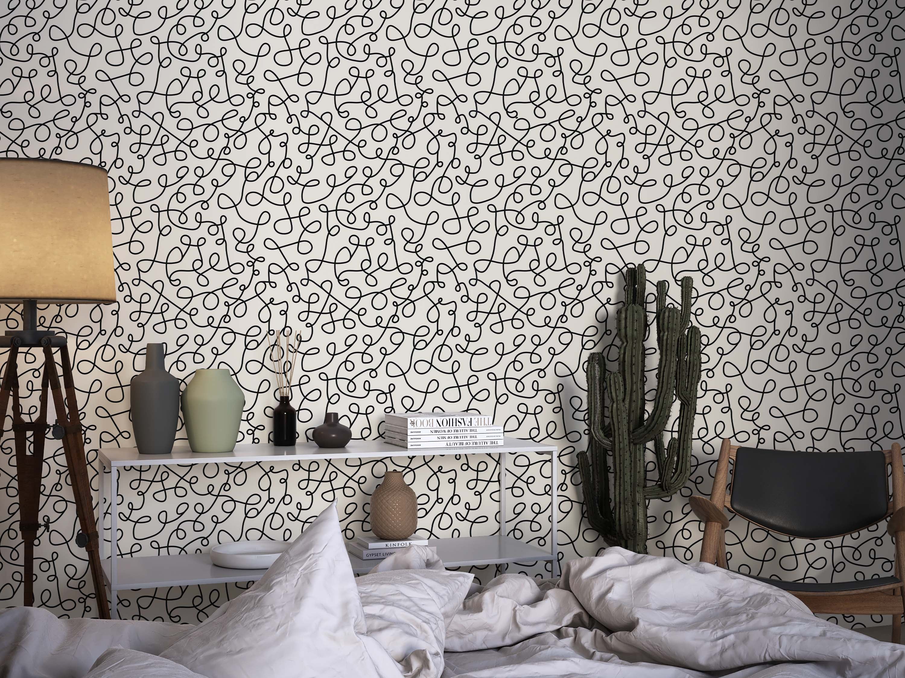 Wallpaper featuring a pattern of continuous black squiggly lines forming interlocking loops on an off-white background.