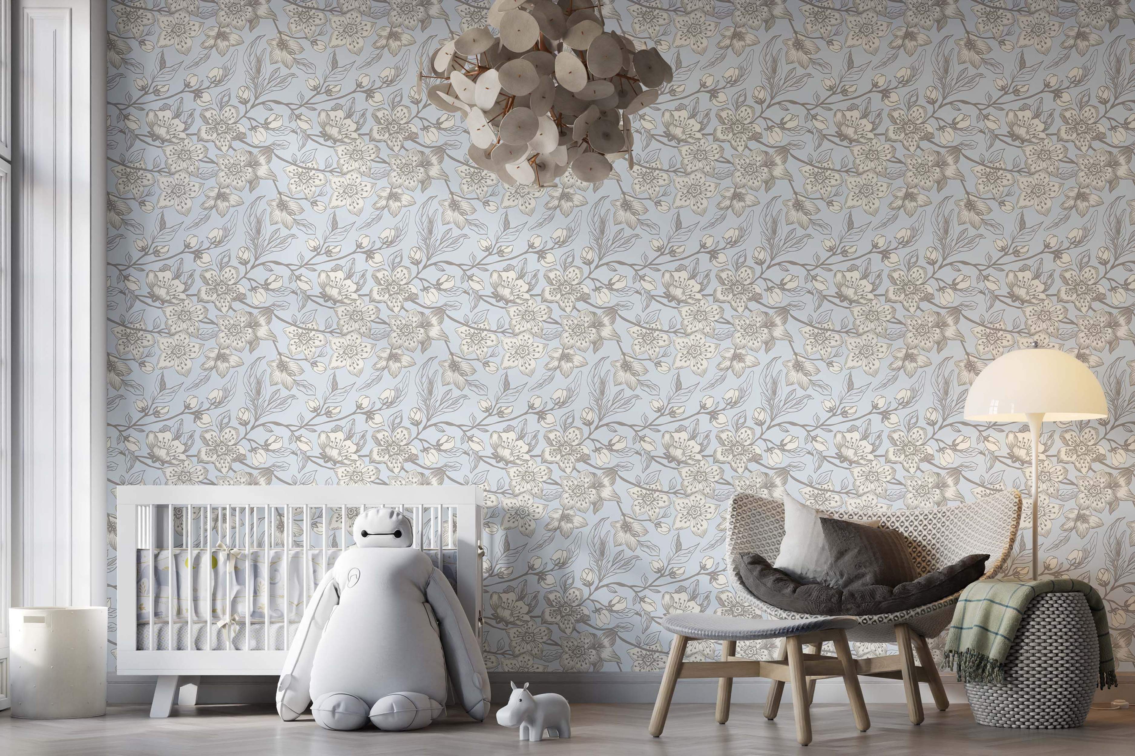 Illustrated floral wallpaper with beige blossoms and gray leaves on winding branches against a light blue backdrop.