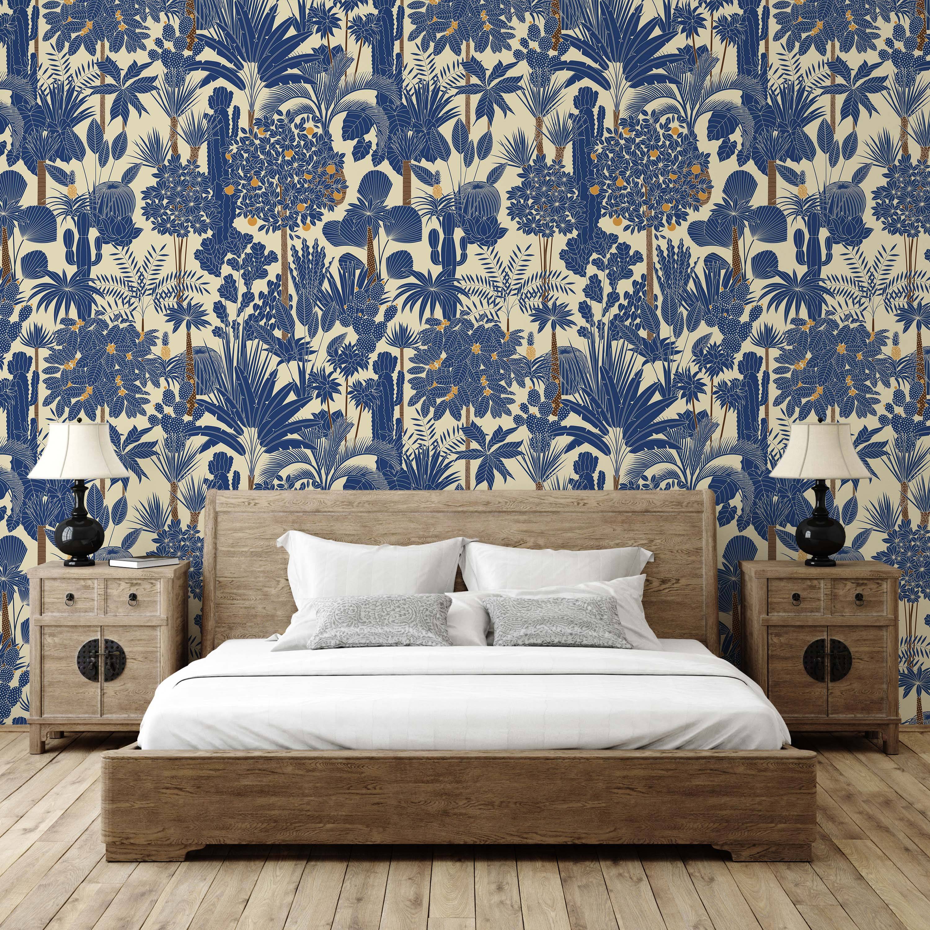 Tropical jungle wallpaper in blue and cream, featuring stylized palm trees, cacti, and plants with small yellow fruits.