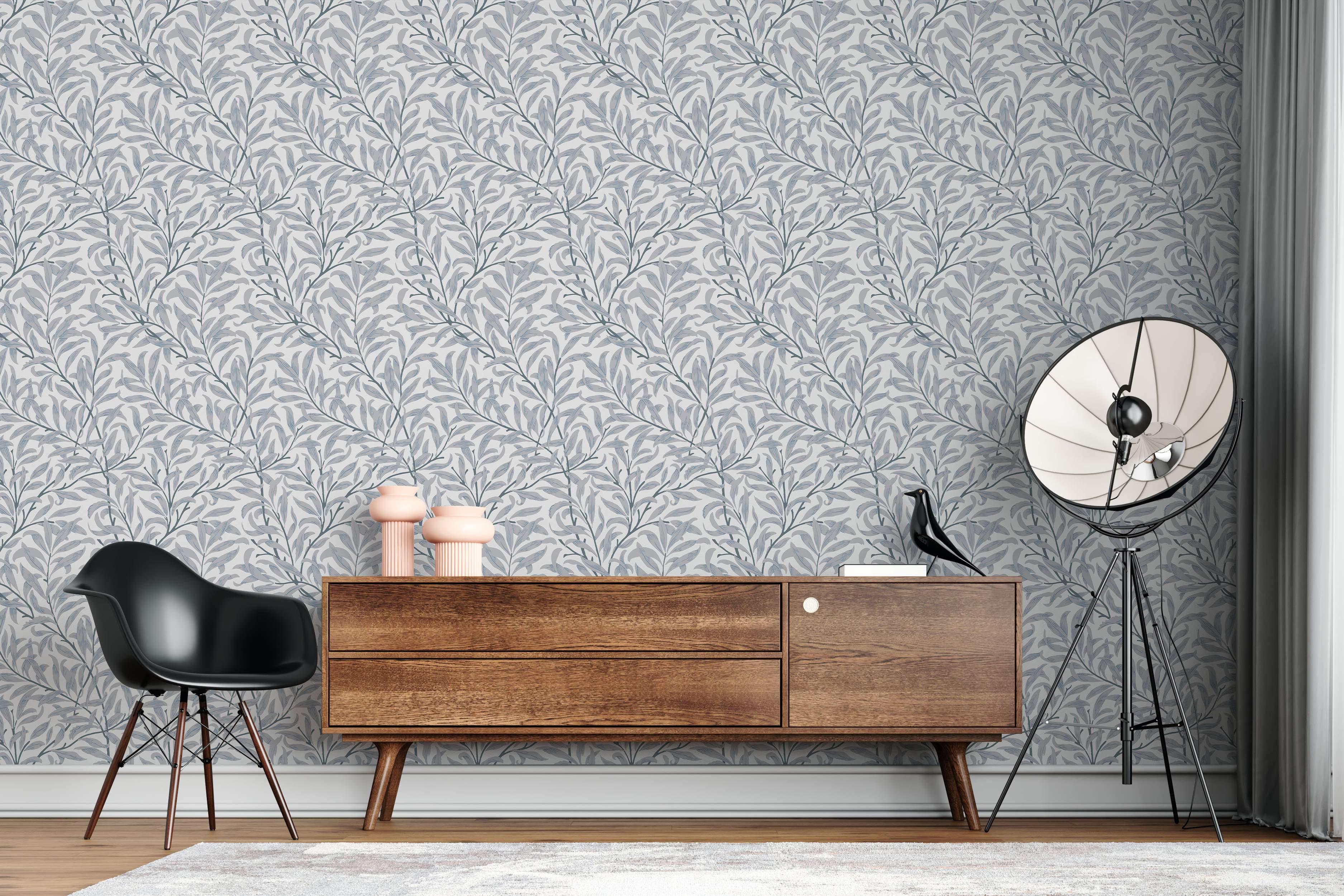 Wallpaper featuring a repeating pattern of intertwining willow-like branches with muted blue-grey leaves on a light grey backdrop.