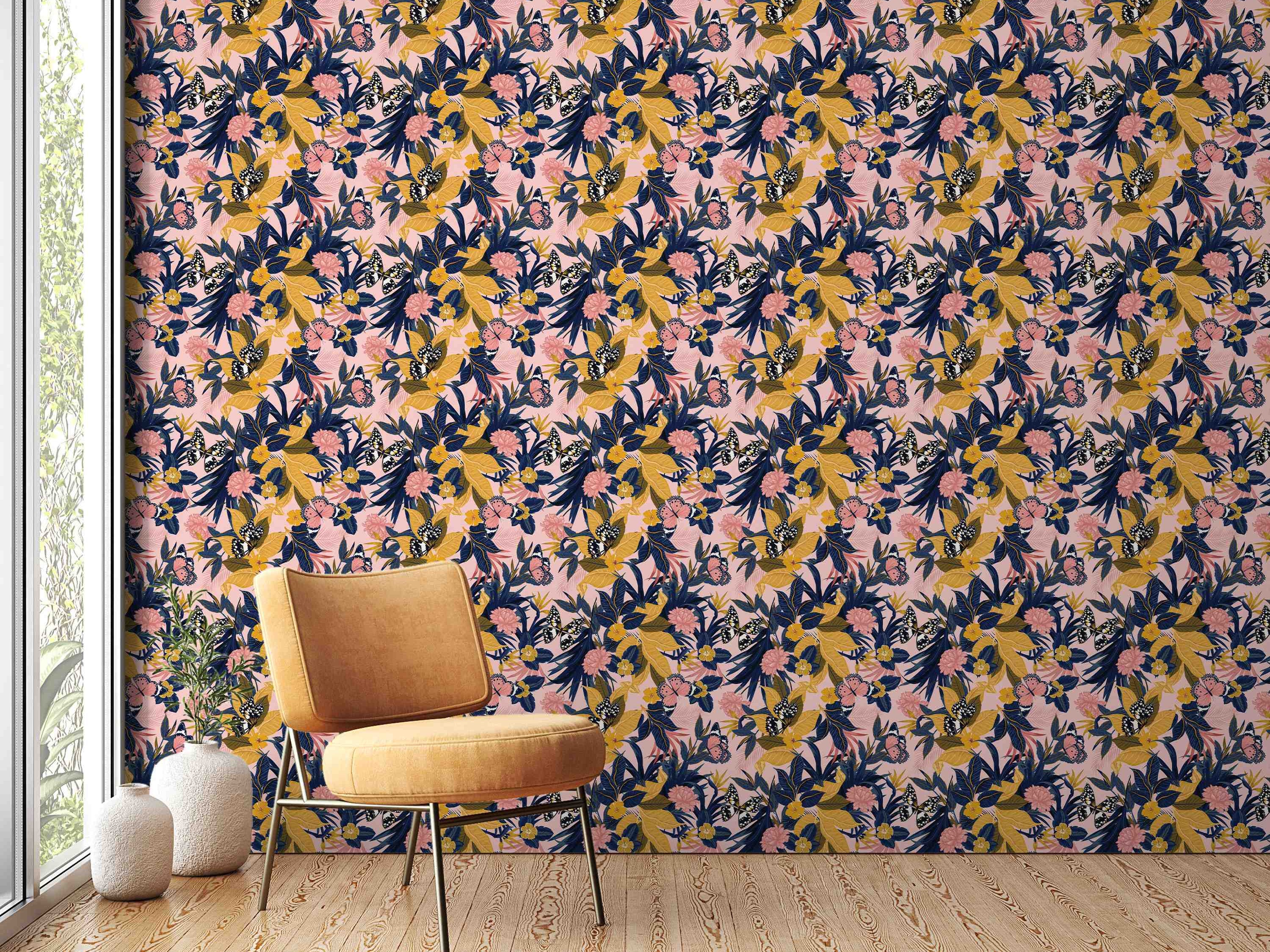 Botanical wallpaper featuring navy blue and mustard yellow leaves, pink flowers, and butterflies on a soft pink background.