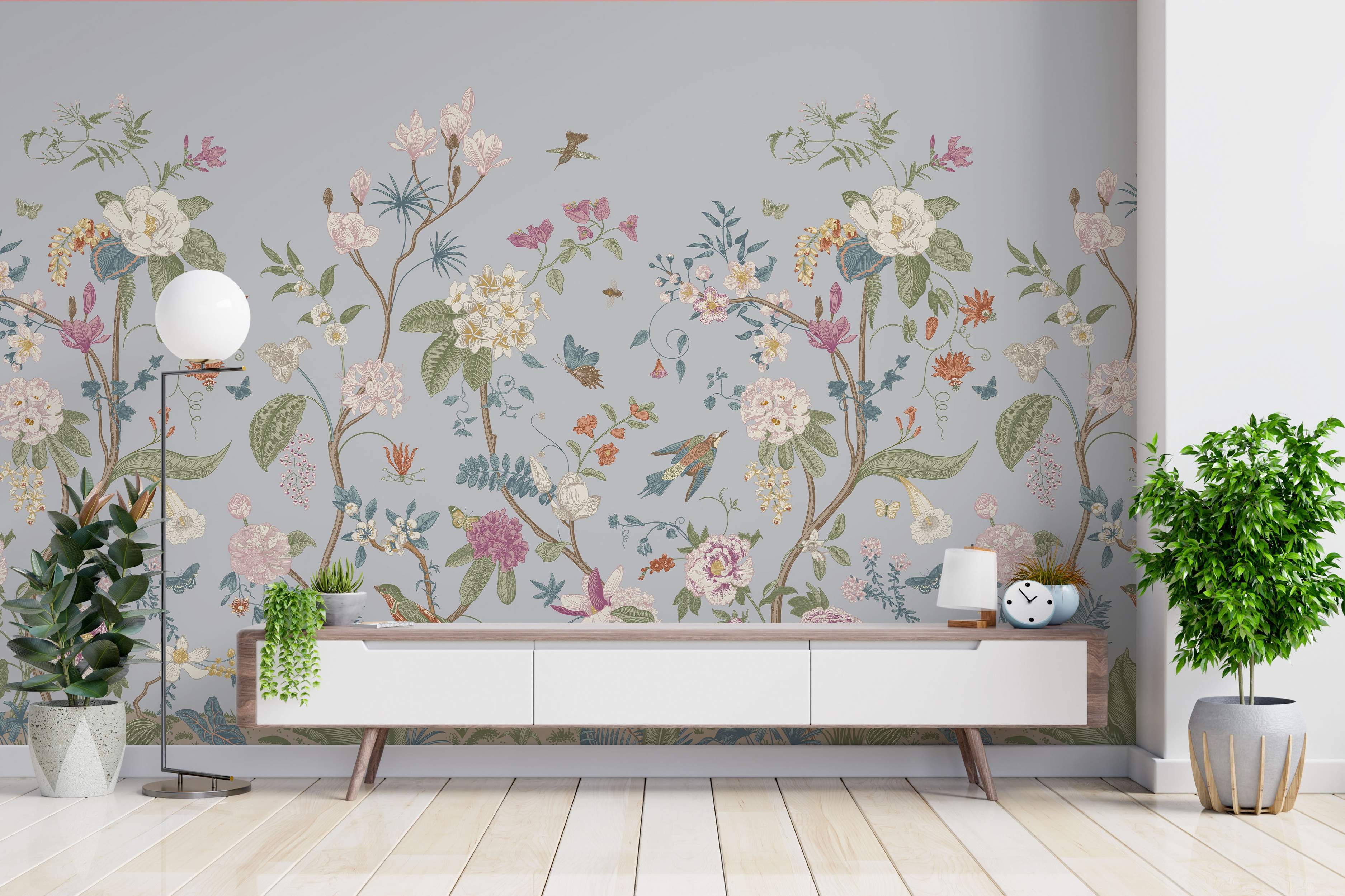 Detailed botanical mural featuring various flowers, birds, and butterflies in pink, white, green, and orange on a soft blue-gray background.