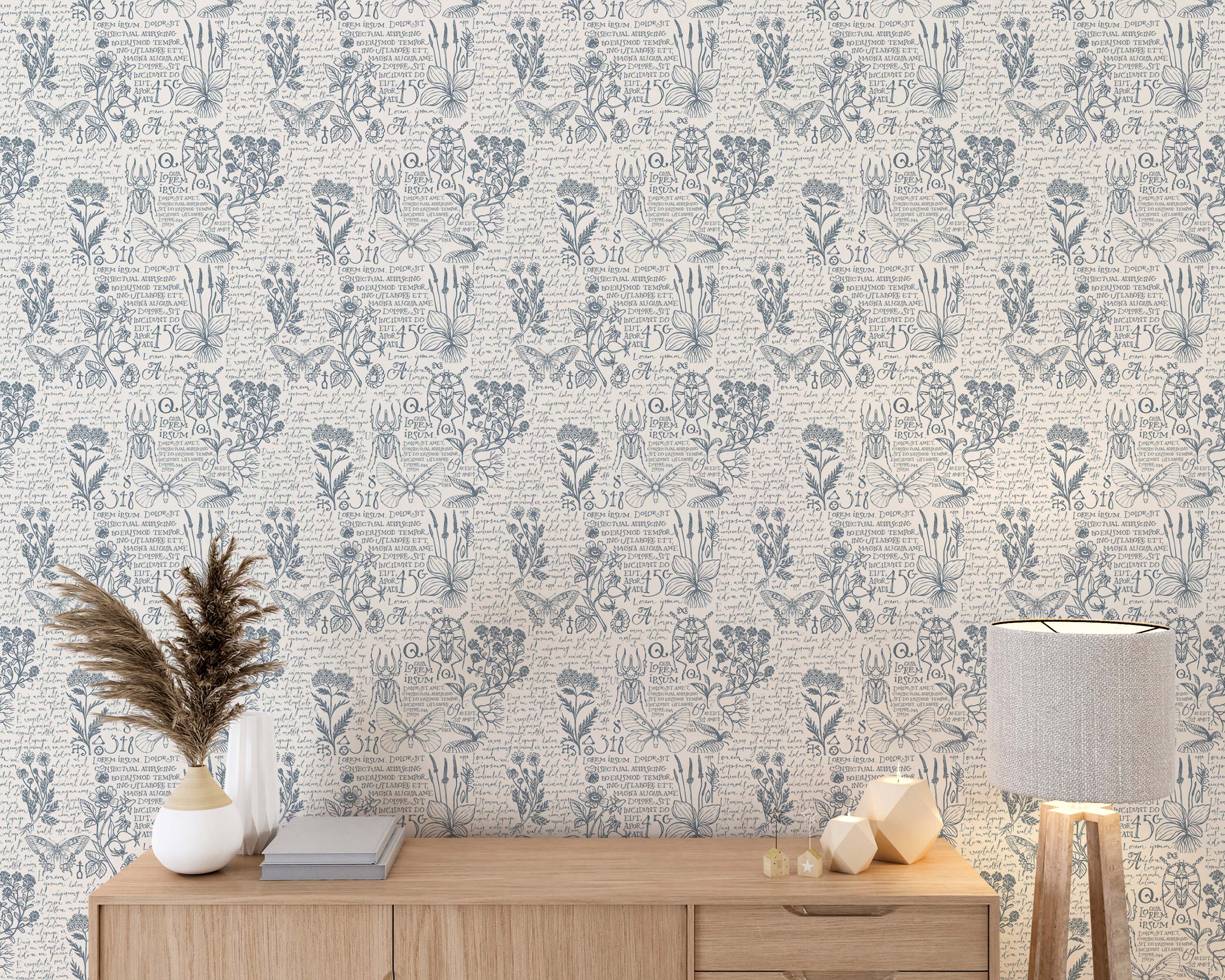 Vintage botanical wallpaper with blue hand-drawn illustrations of flowers, insects, and script on an off-white background.