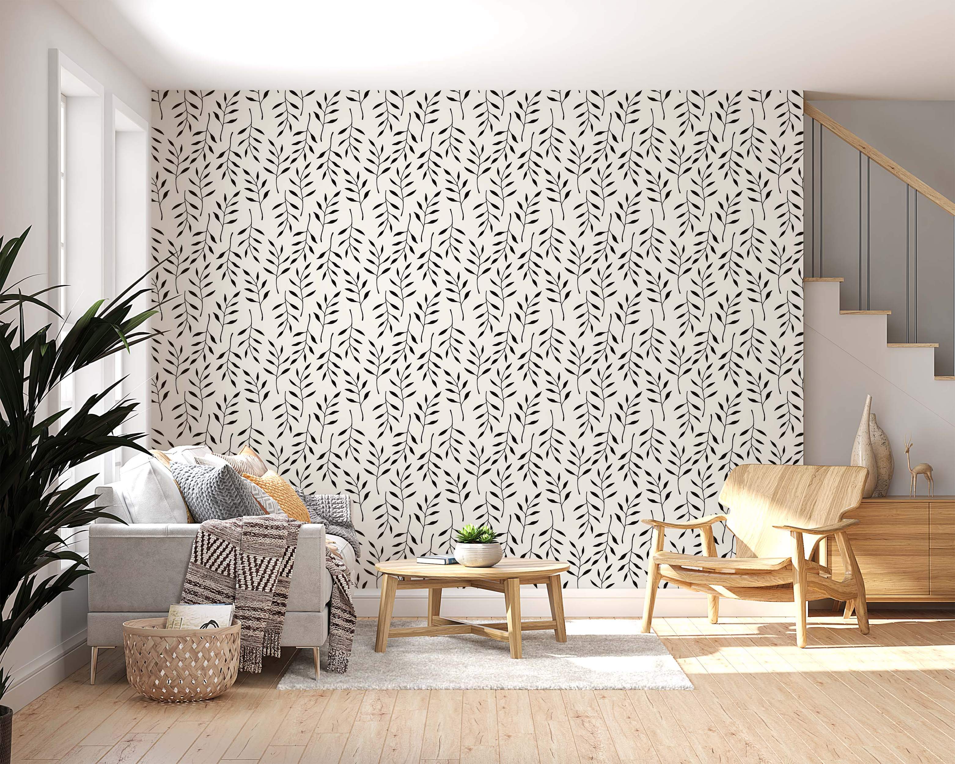 Minimalist wallpaper featuring a repeating pattern of simple black botanical sprigs on an off-white background.
