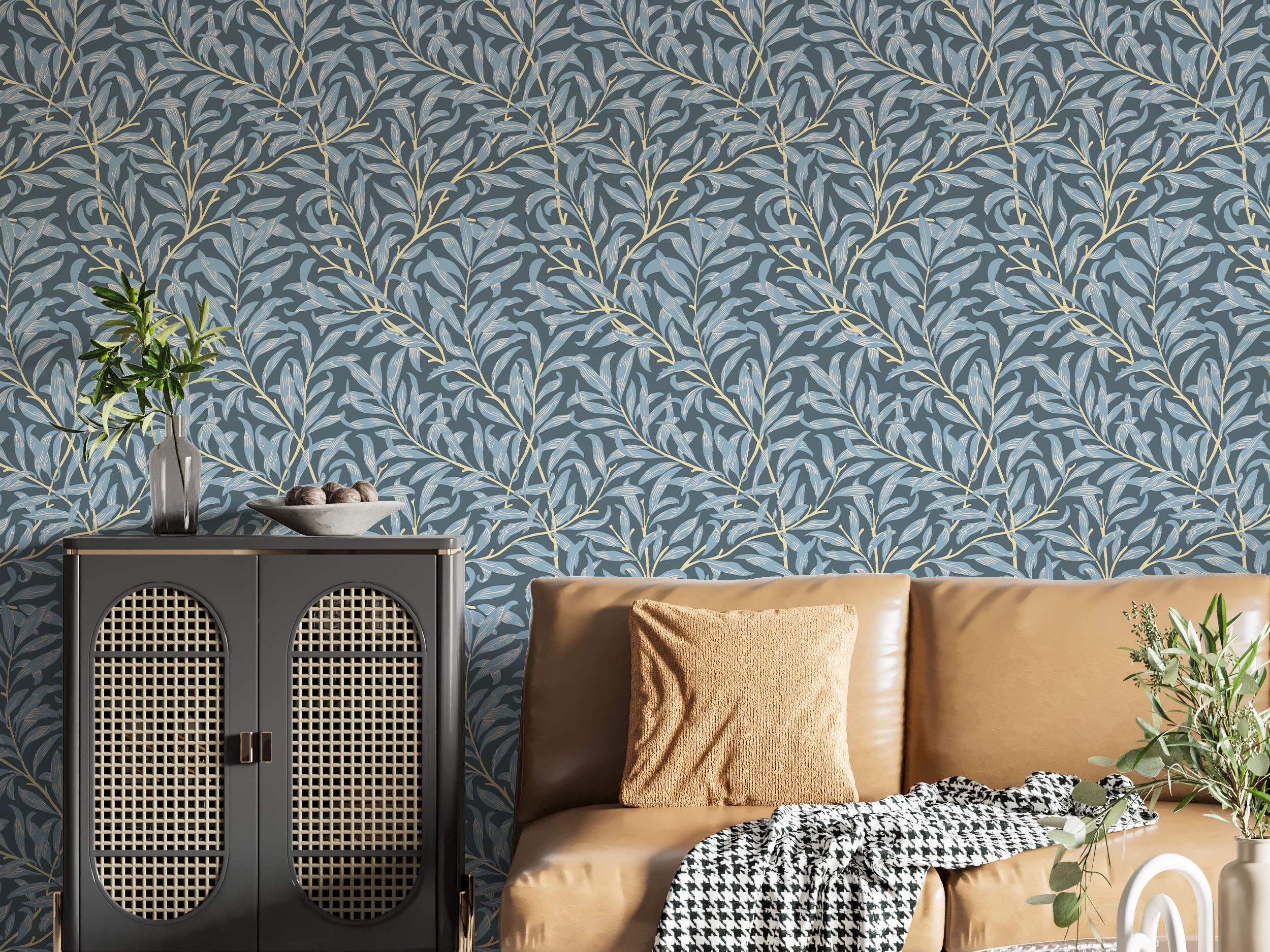 Wallpaper showing a repeating pattern of stylized light blue leaves on pale yellow branches over a dark blue-grey background.