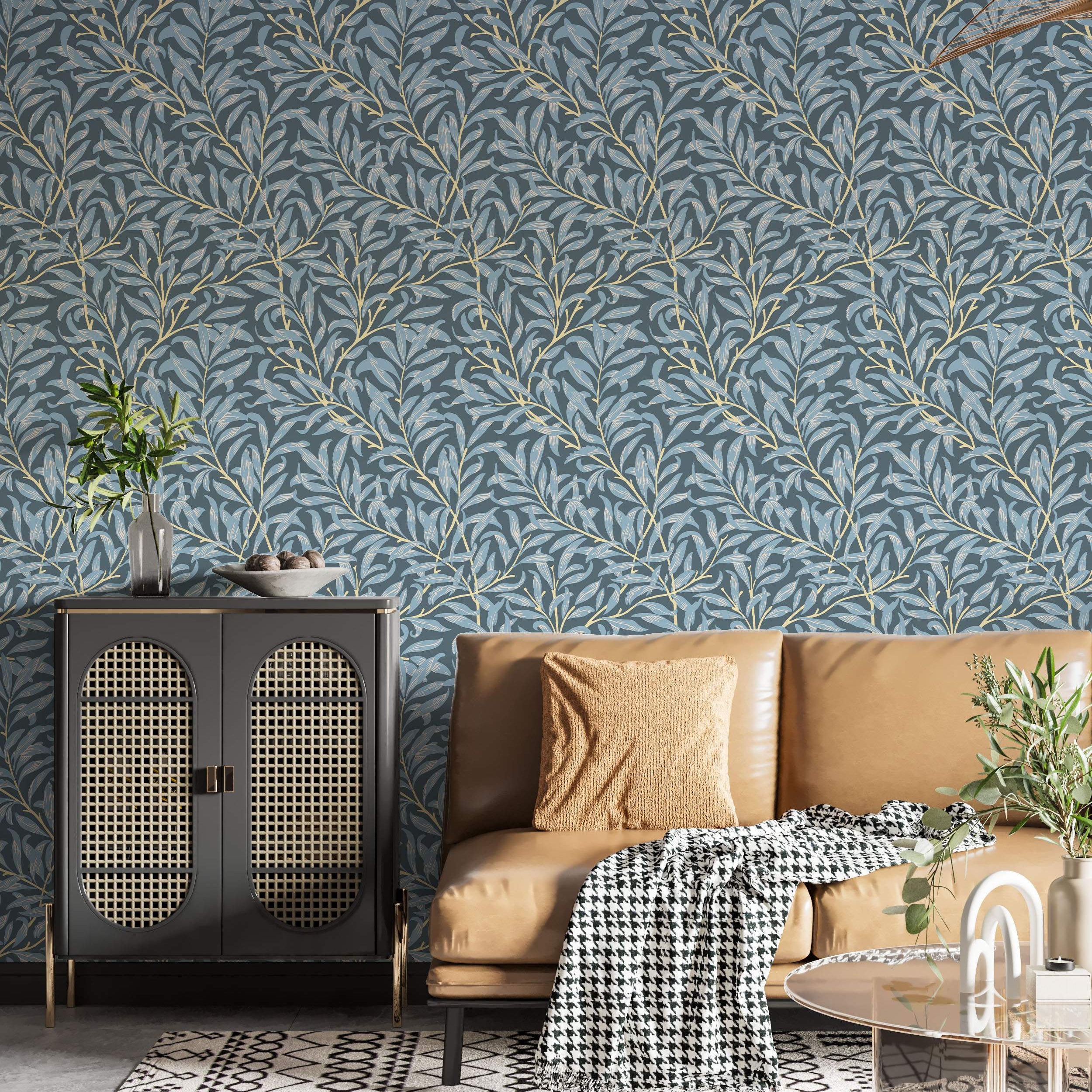Wallpaper showing a repeating pattern of stylized light blue leaves on pale yellow branches over a dark blue-grey background.