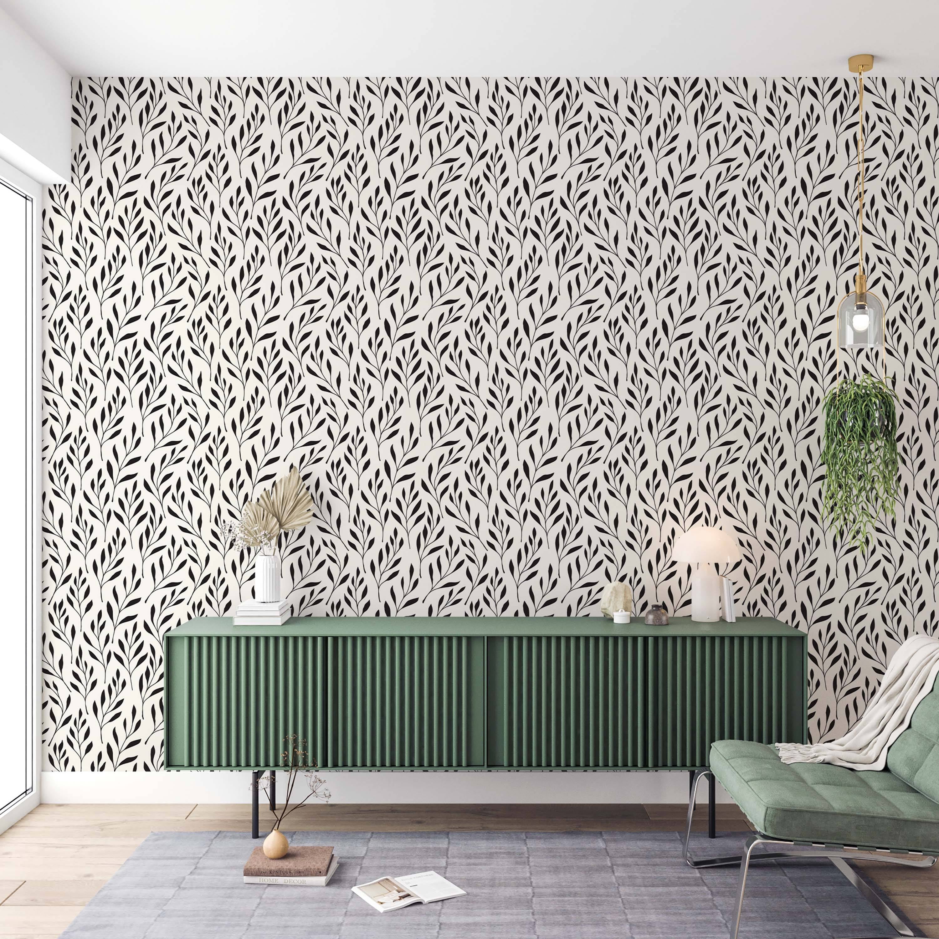 Wallpaper featuring a repeating pattern of stylized black leafy branches on a light cream background.