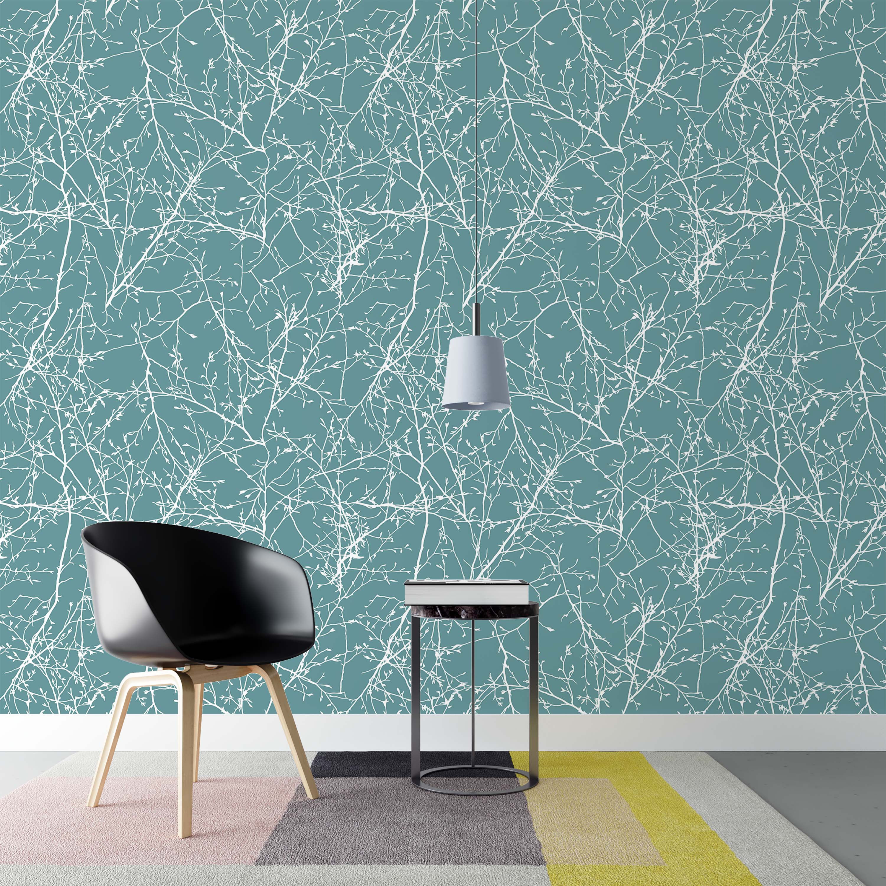Wallpaper with a pattern of tangled white tree branches and twigs on a solid dusty teal background.