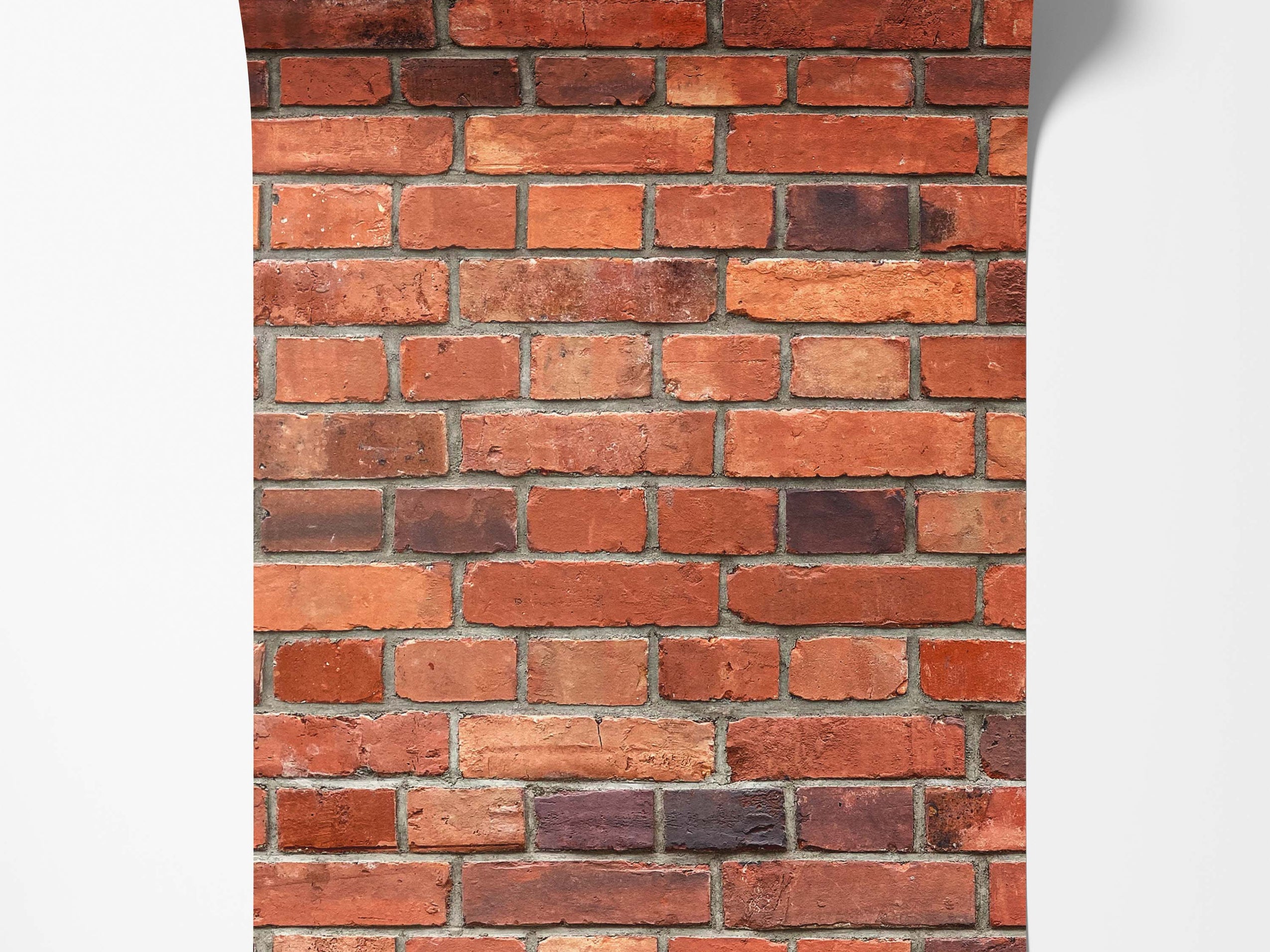 Realistic red brick wallpaper with varied shades of red, orange, and dark brown bricks, detailed with grey mortar lines.