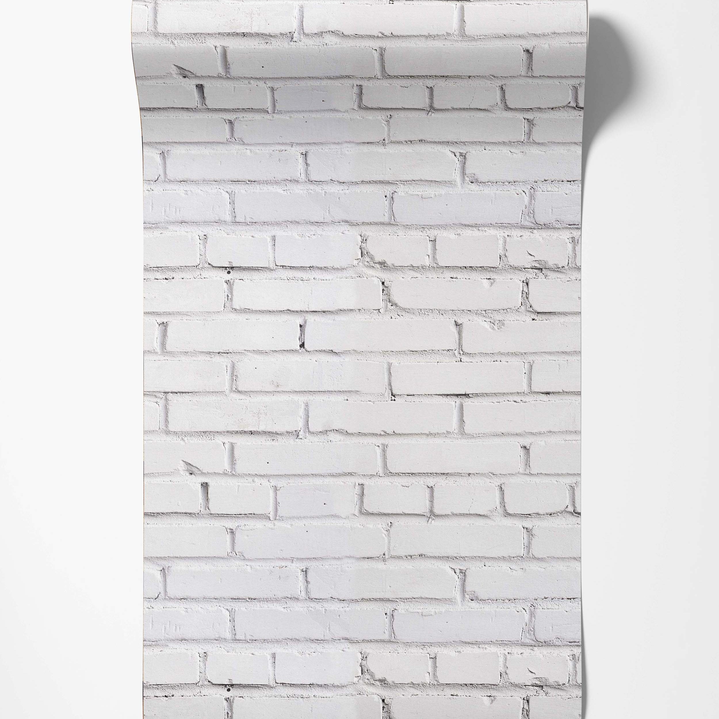 Wallpaper featuring a realistic white painted brick pattern with visible texture and light gray mortar lines.