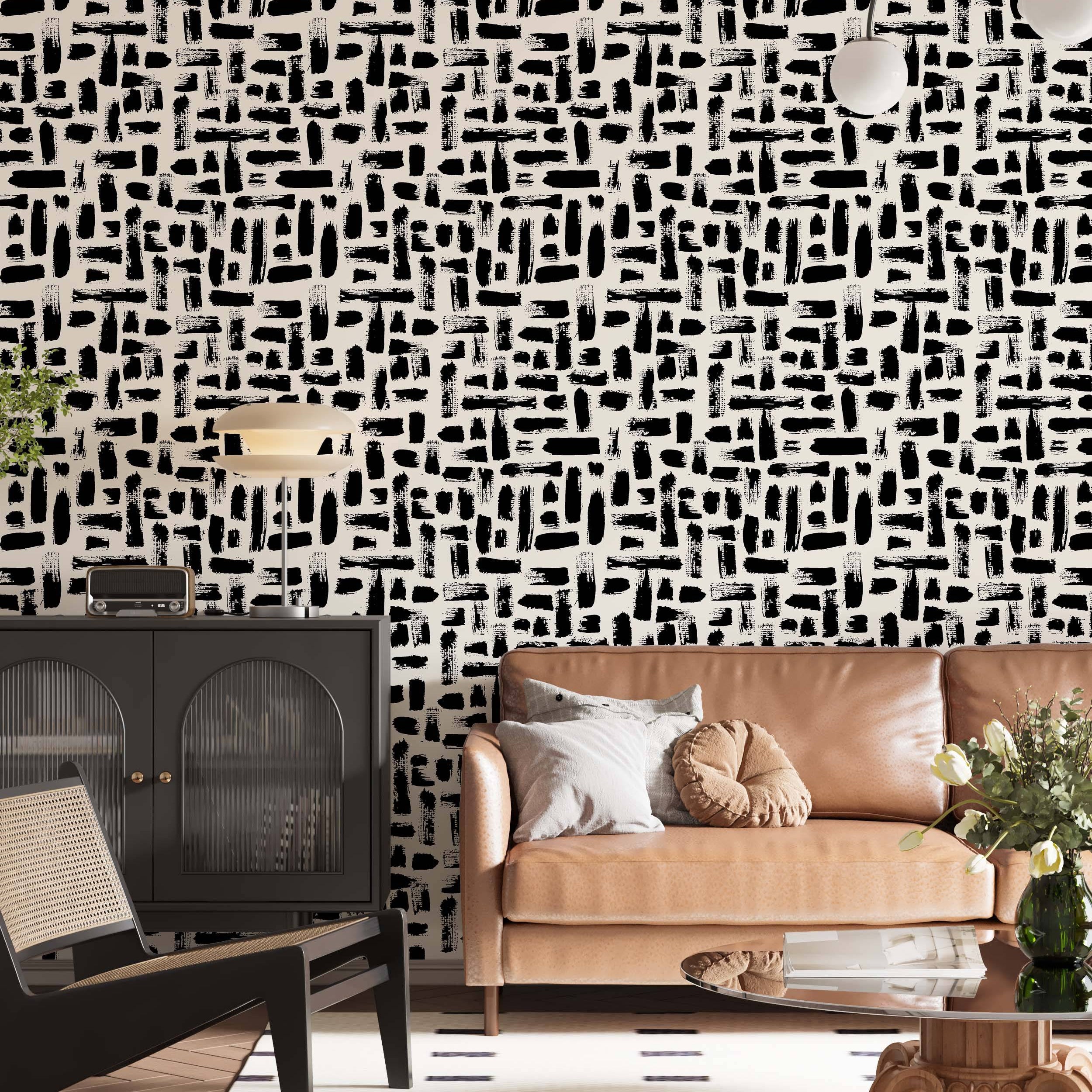 Abstract wallpaper featuring varied black brushstrokes scattered across a light beige background.