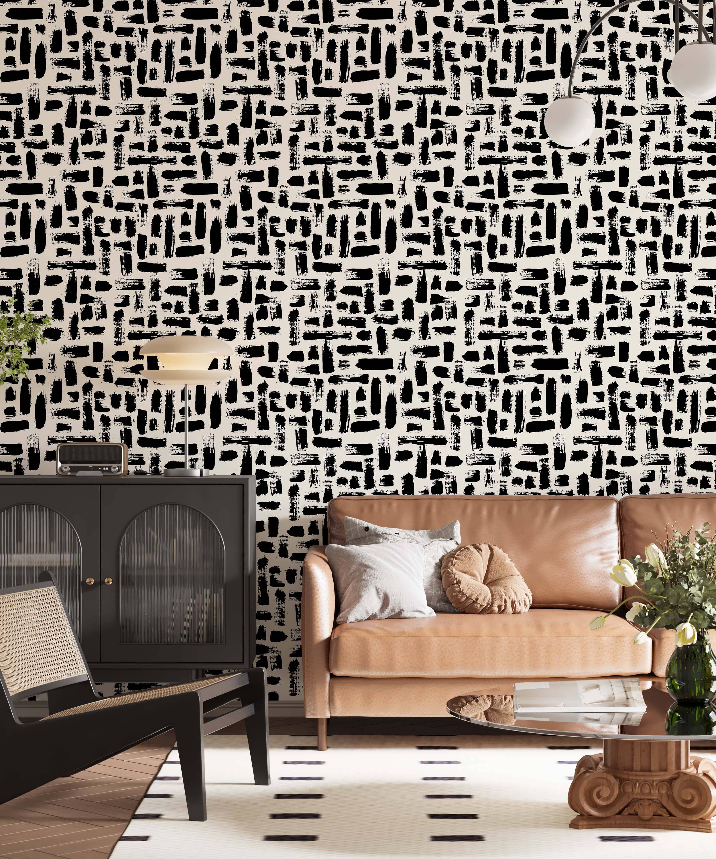 Abstract wallpaper featuring varied black brushstrokes scattered across a light beige background.