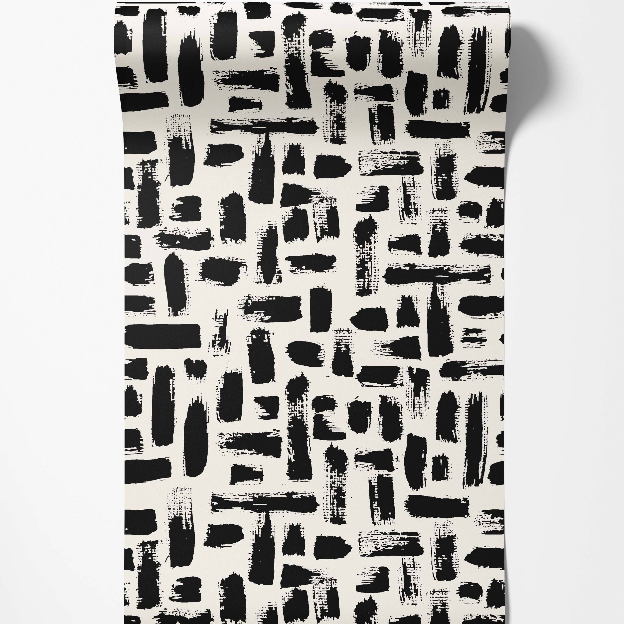 Abstract wallpaper with textured black brushstrokes randomly scattered across an off-white background.