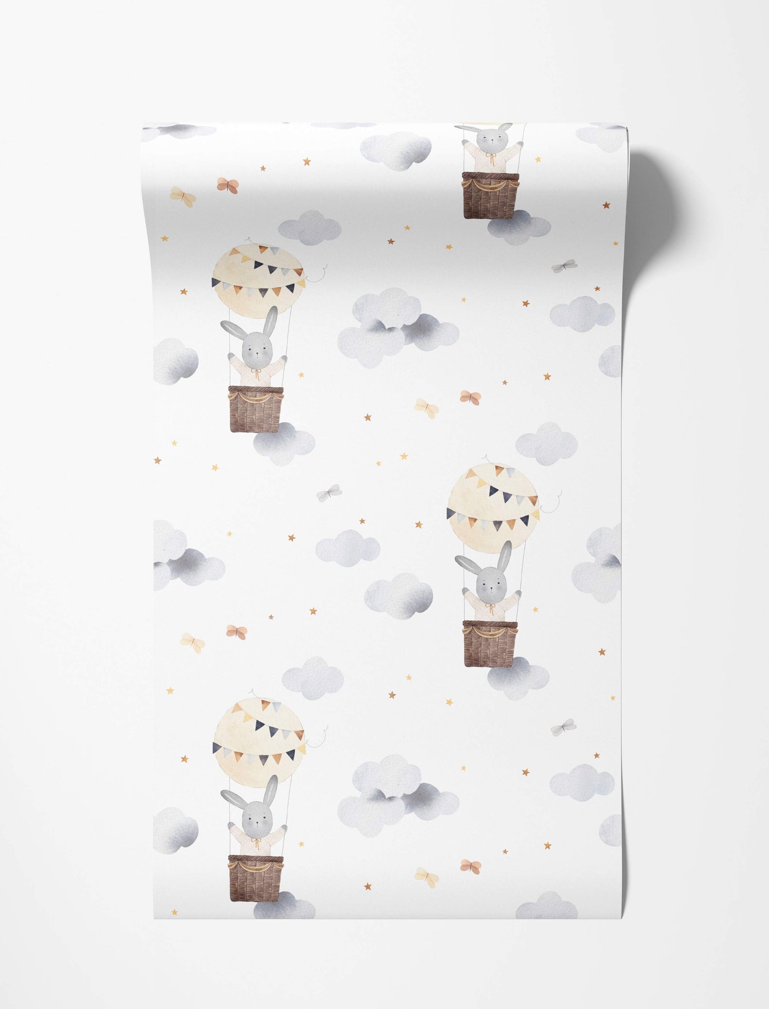 Watercolor wallpaper featuring cute grey bunnies in hot air balloons floating among grey clouds and yellow stars on a white background.
